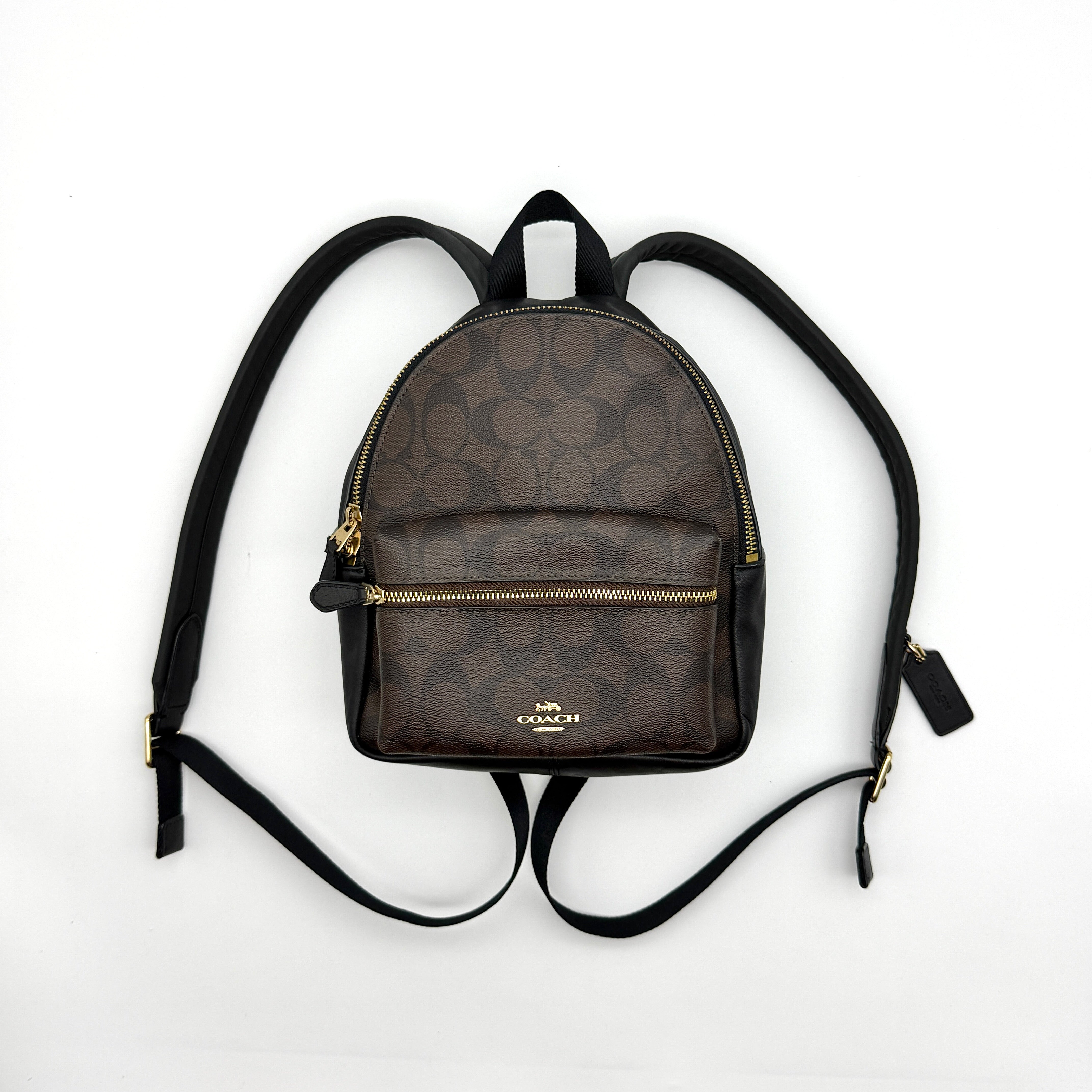 Coach Signature Mini Charlie Backpack in brown and black coated canvas with gold-tone hardware and leather trim — pre-loved.