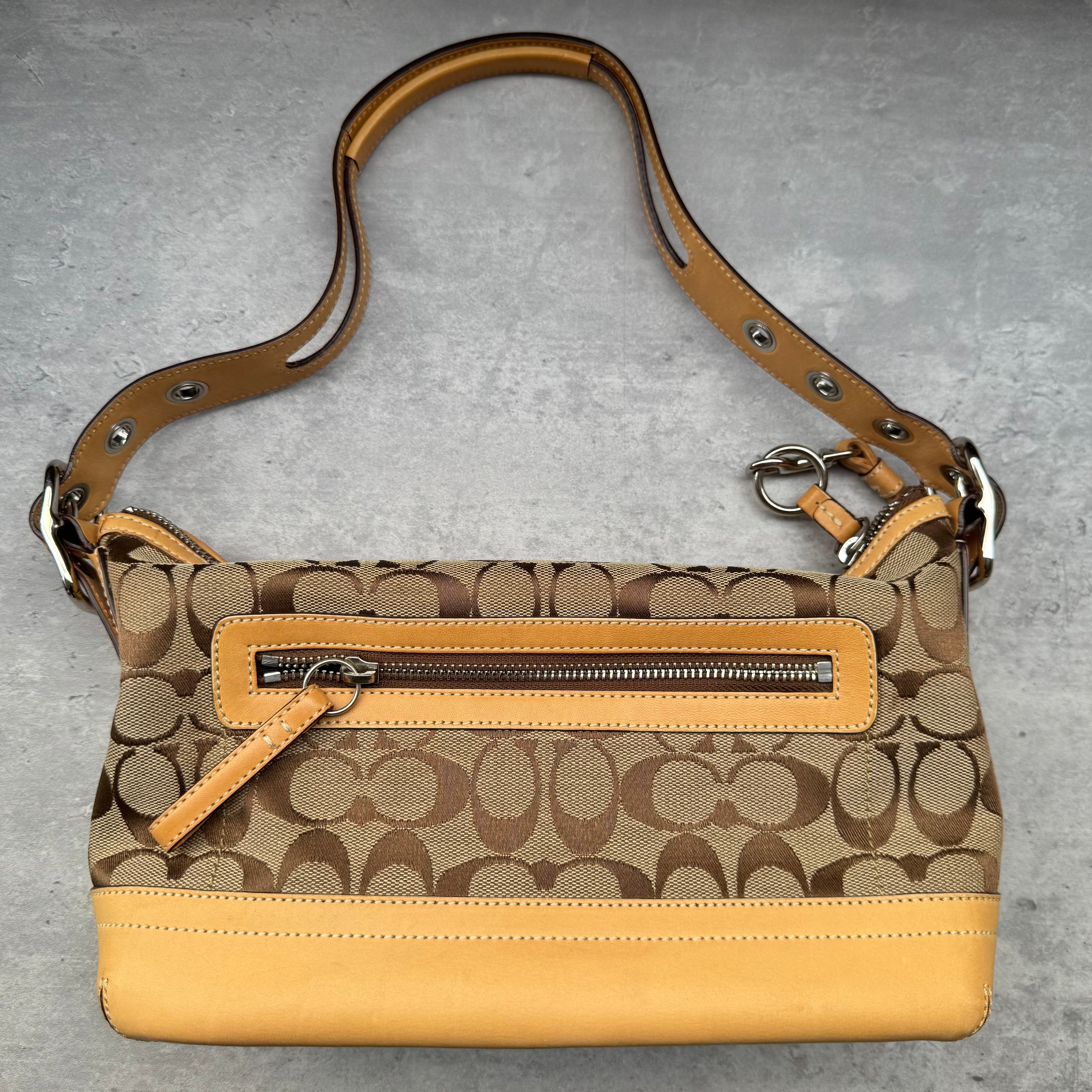 Coach Signature Coated Canvas Tassel Shoulder Bag in brown monogram print with tan leather trim and tassel detail.