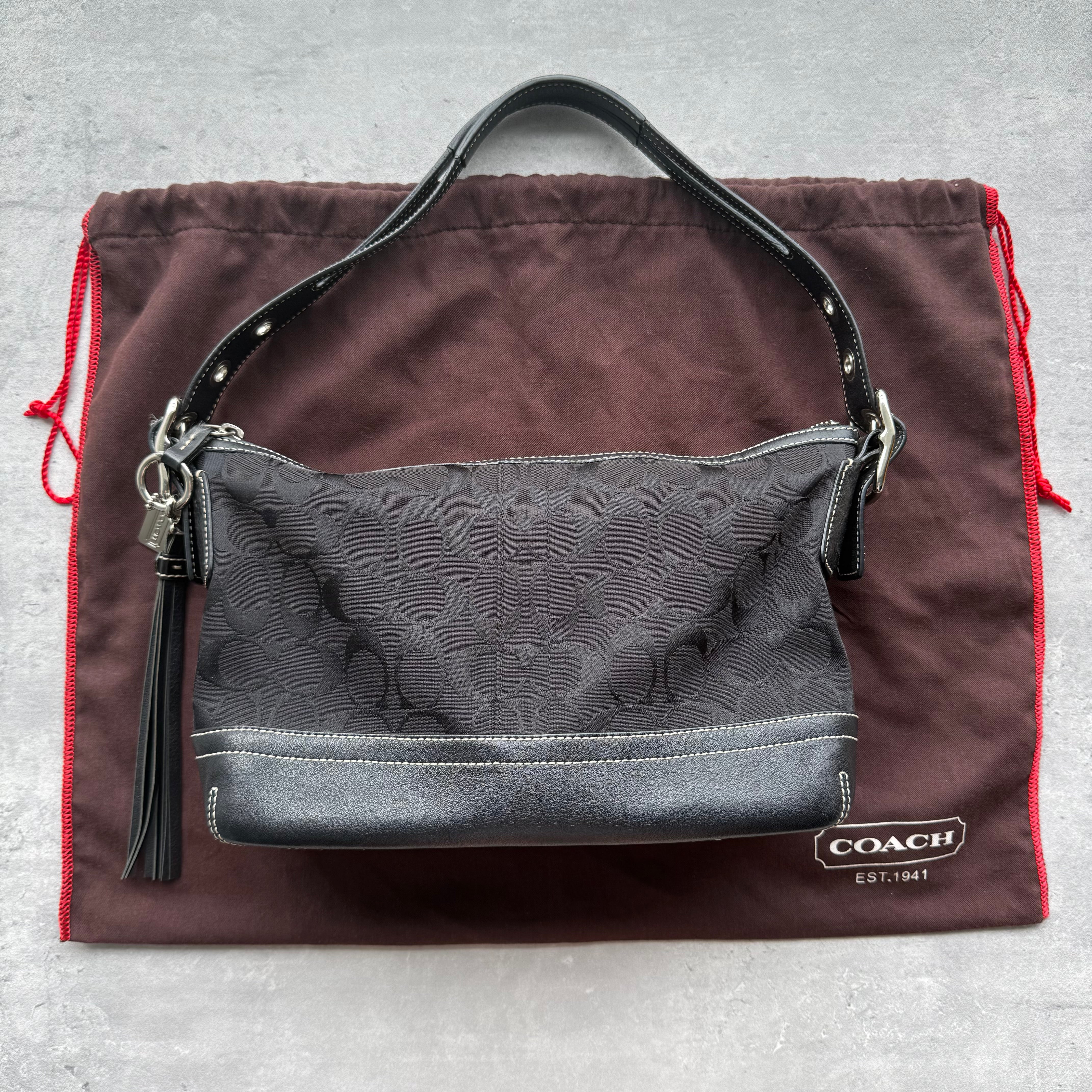Coach Signature East West Shoulder Bag in black jacquard with leather trim, silver-tone zip, and adjustable strap