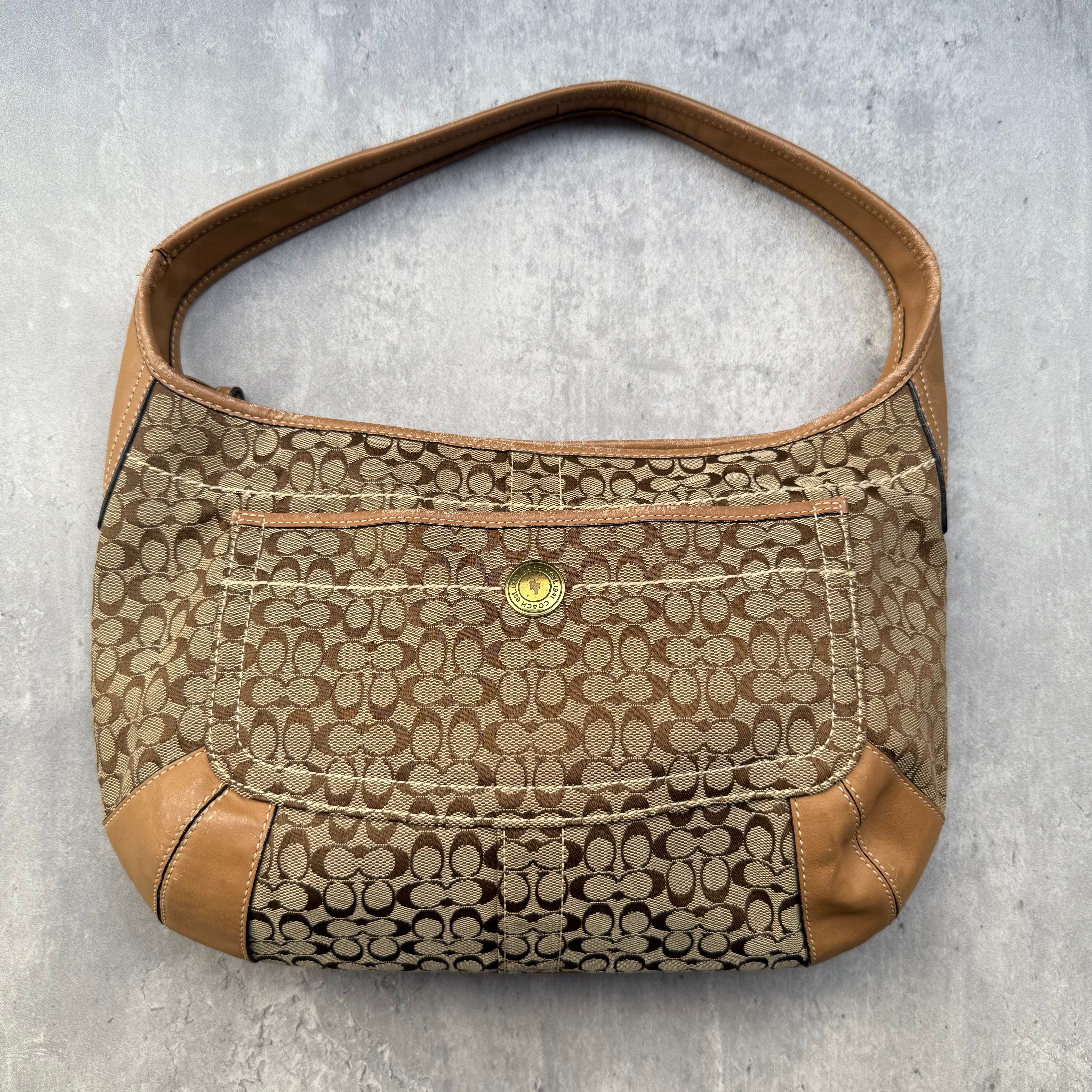 Coach Signature Ergo Hobo Shoulder Bag in beige and tan jacquard canvas with leather trim and curved shoulder strap.