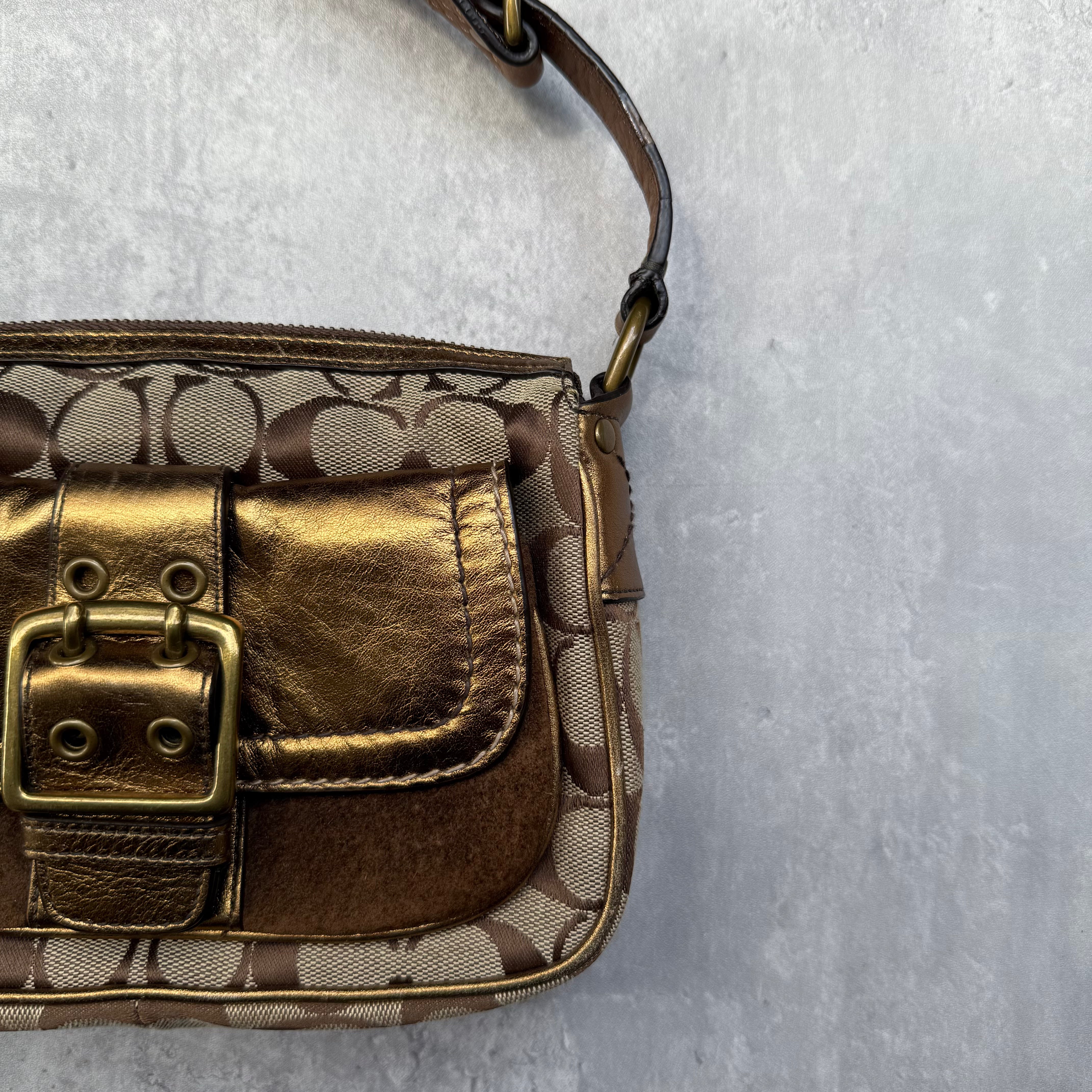 Coach Signature Shoulder Bag in beige canvas with gold metallic front buckle pocket, brown suede accents, and short strap.