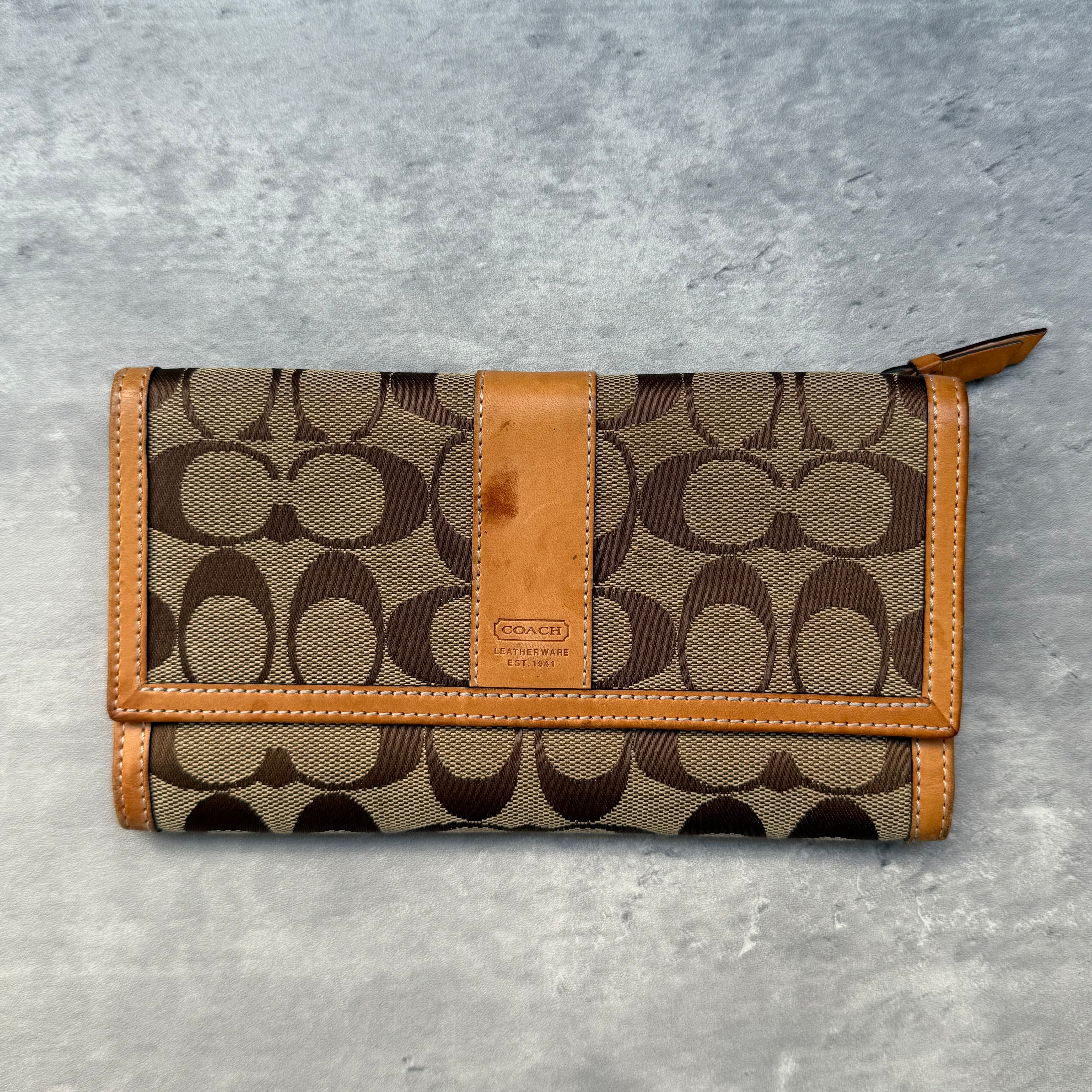 Coach Signature Jacquard Long Wallet Beige with tan leather trim, featuring multiple card slots, ID window, and zip compartment.