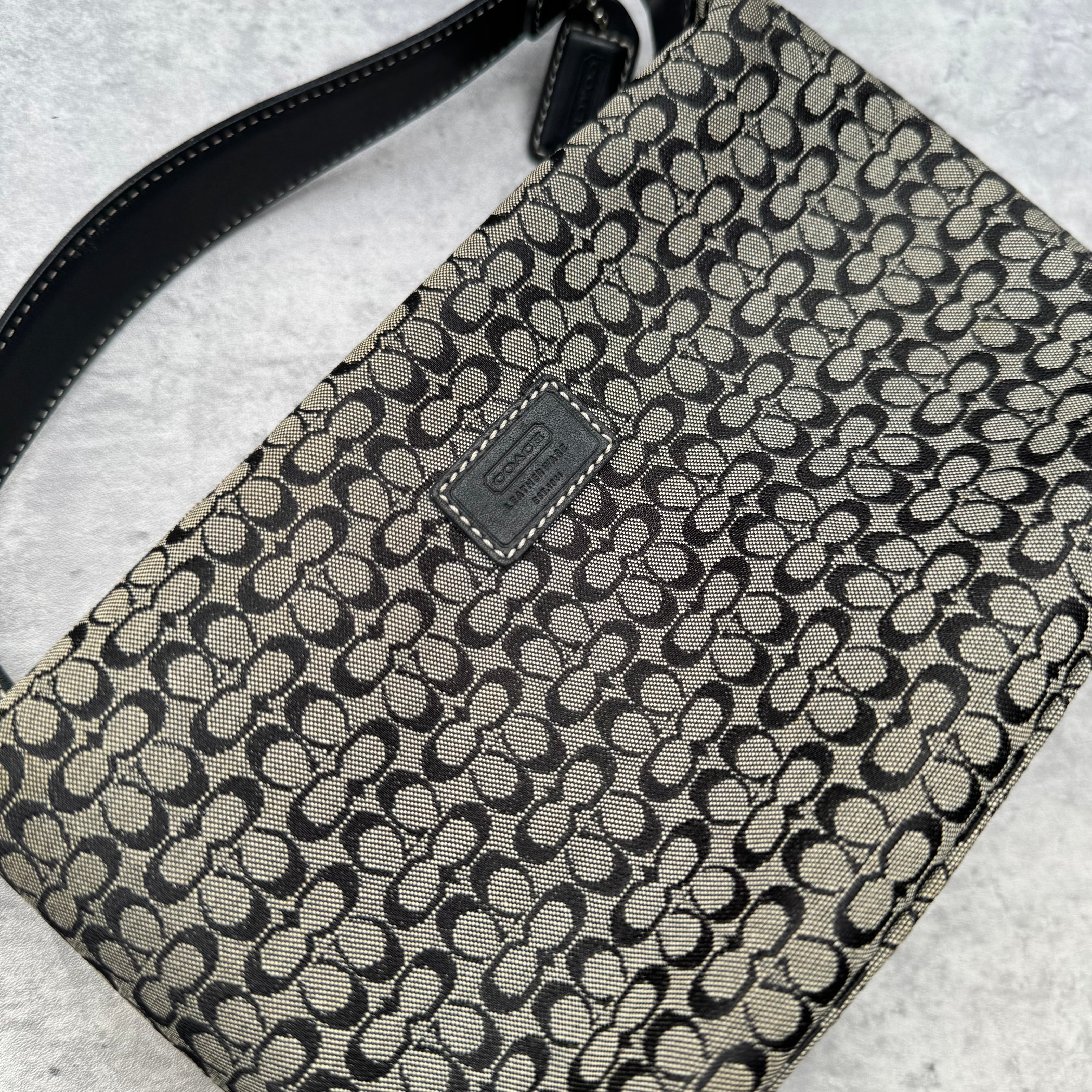 Coach Signature Mini Hobo Shoulder Bag in grey and black canvas with monogram print and black leather trim.