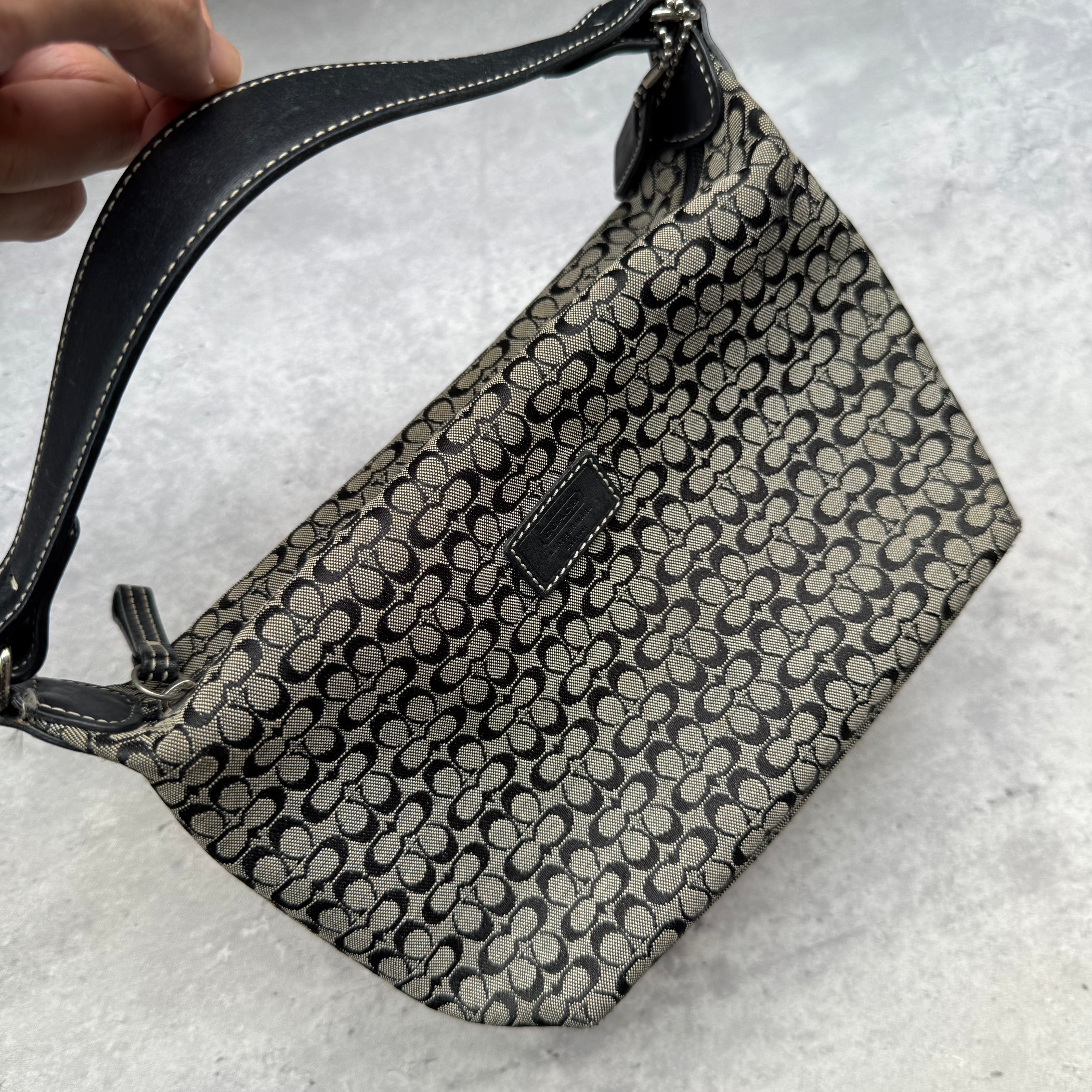 Coach Signature Mini Hobo Shoulder Bag in grey and black canvas with monogram print and black leather trim.