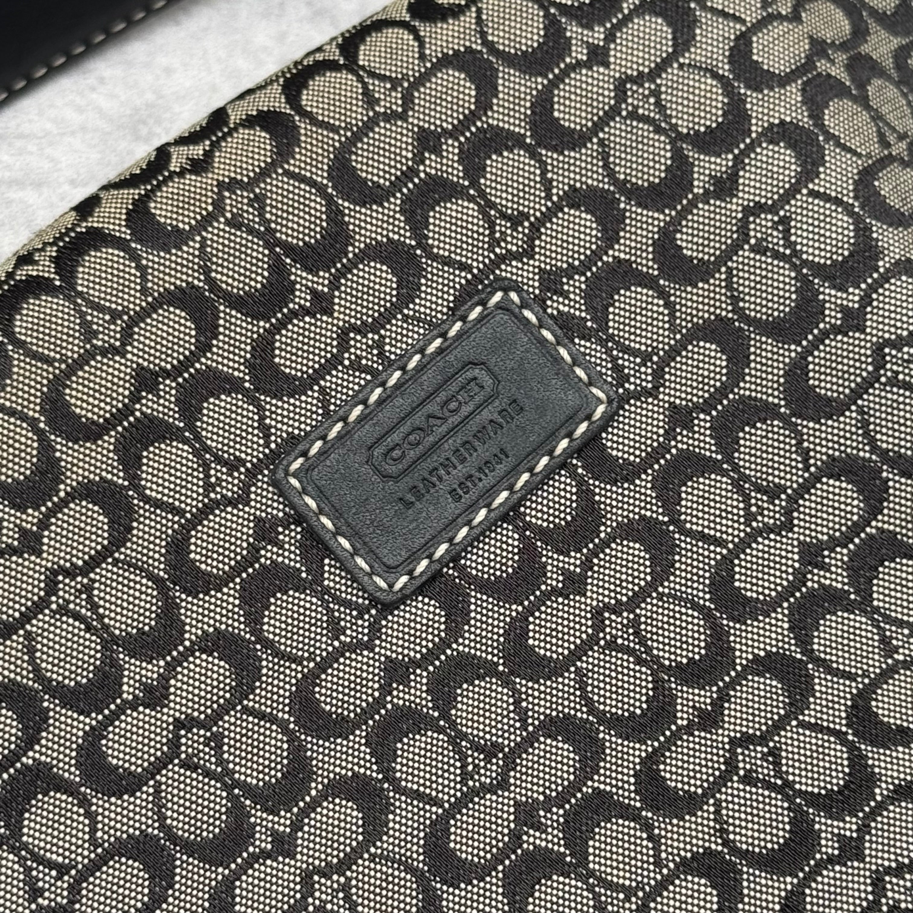 Coach Signature Mini Hobo Shoulder Bag in grey and black canvas with monogram print and black leather trim.