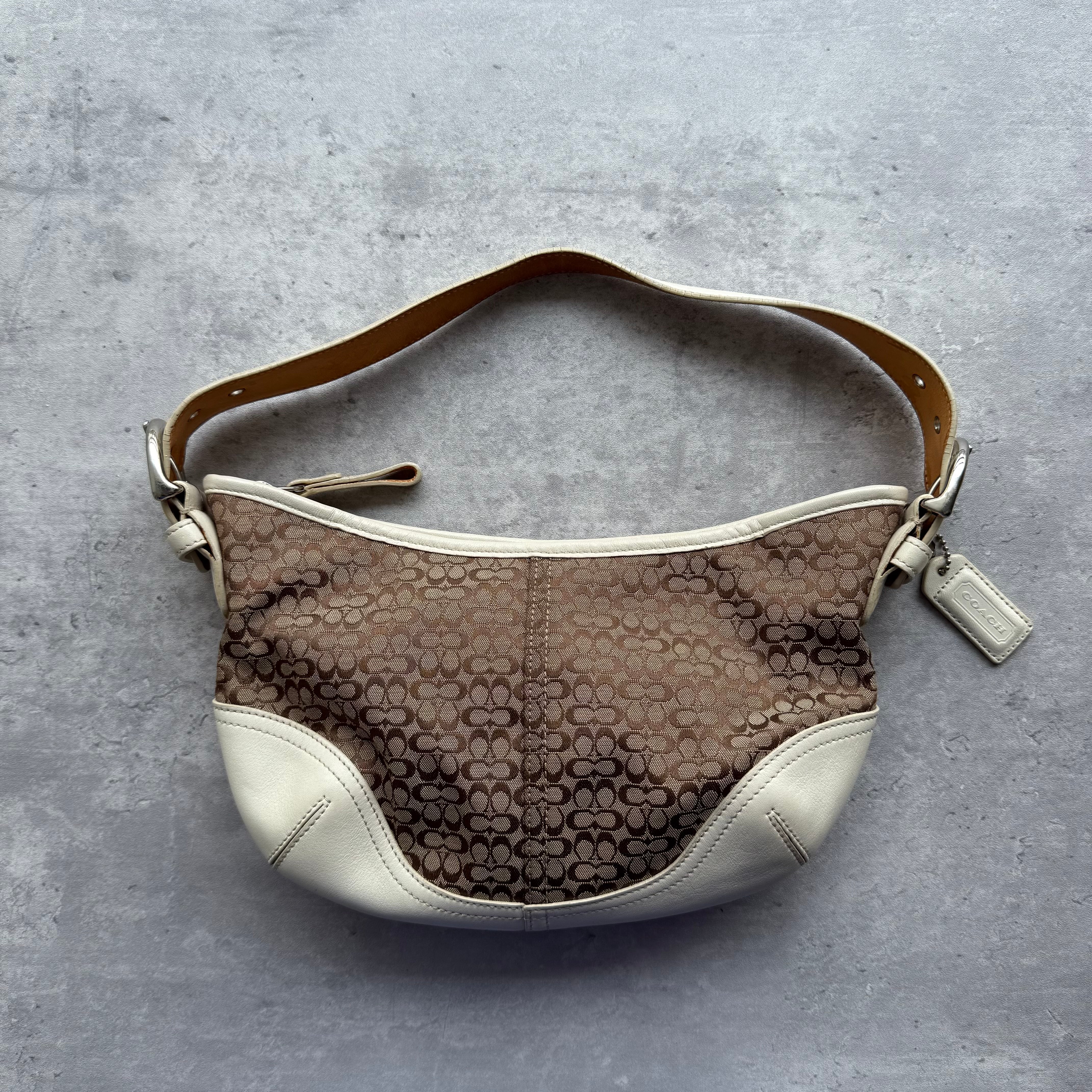 Coach Signature Mini Sufflette Shoulder Bag in beige jacquard with white leather trim, adjustable strap, and beige fabric lining.