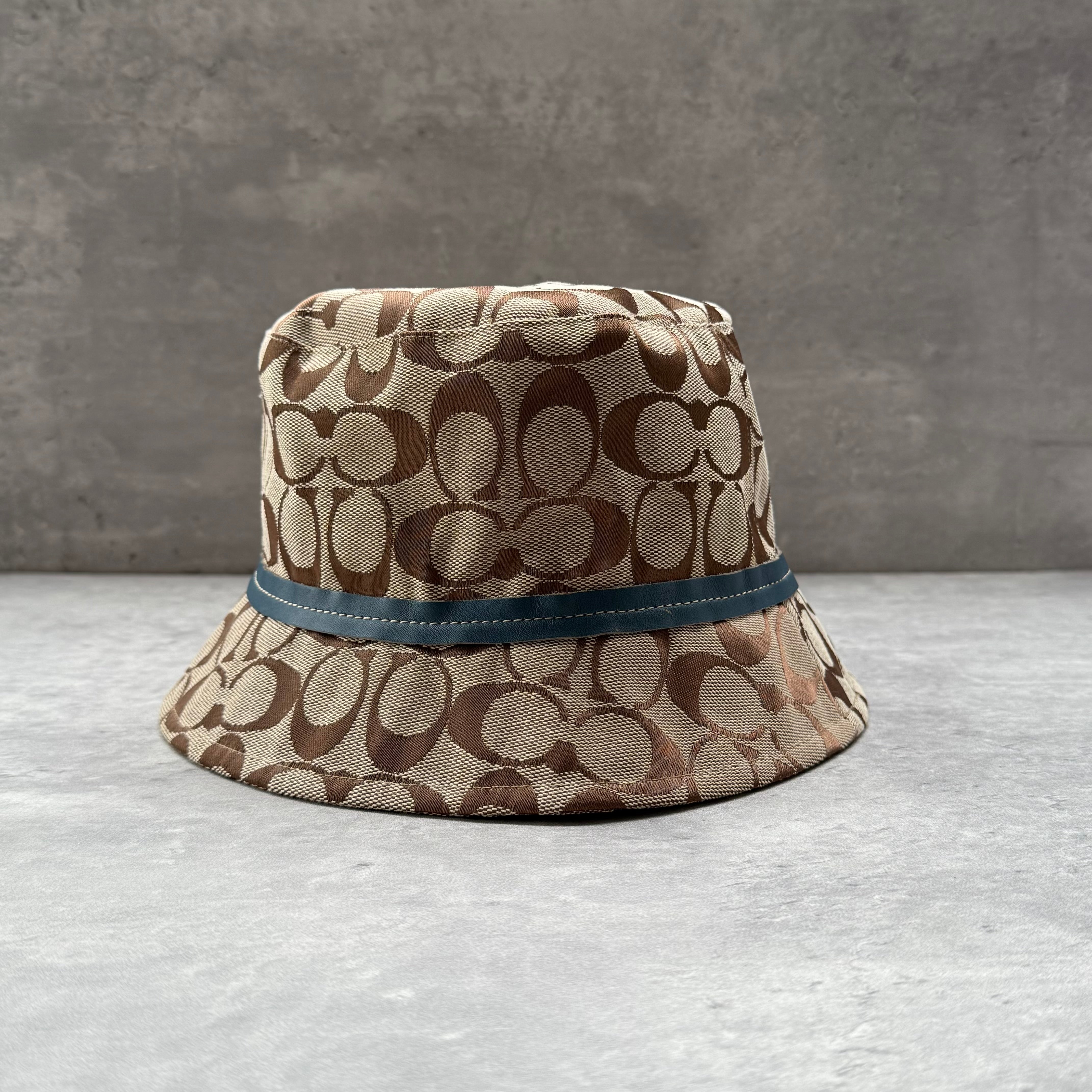 Coach Signature Monogram Bucket Hat Beige with blue accent band and light blue lining – pre-loved designer accessory.