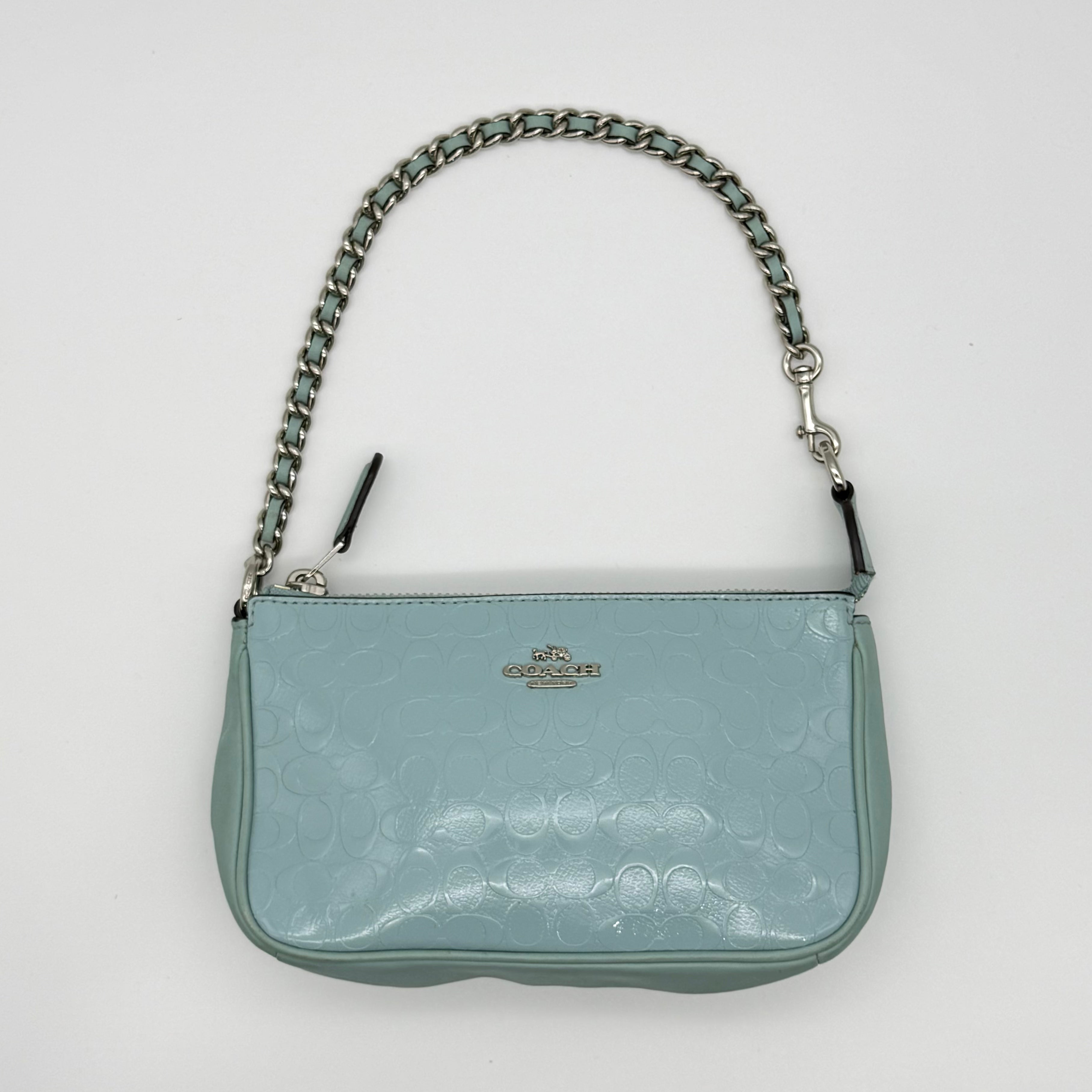 Coach Signature Nolita 19 in light blue embossed leather with chain strap and zip-top — pre-loved.