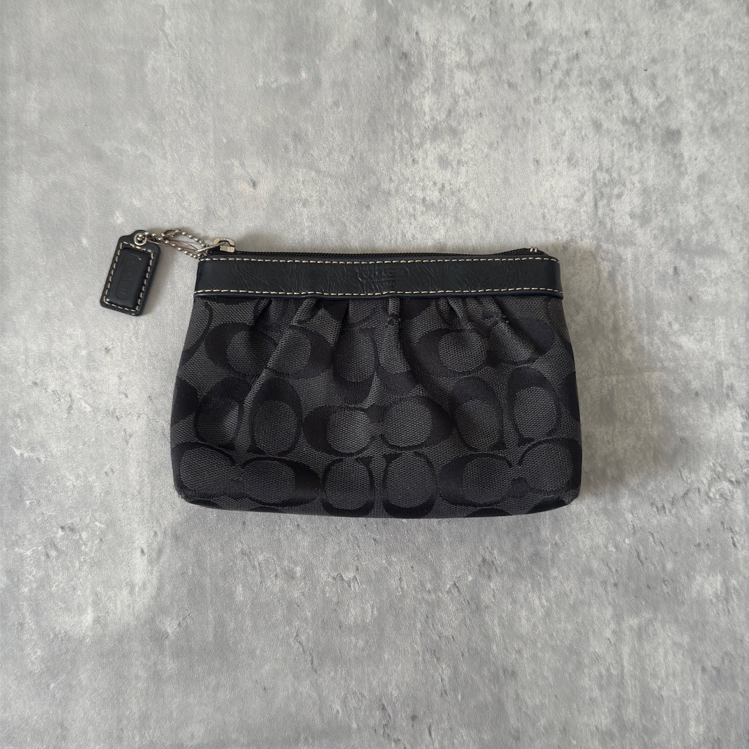 Coach Signature Pleated Black Wristlet with iconic monogram pattern, black leather trim, and red fabric interior, vintage condition.