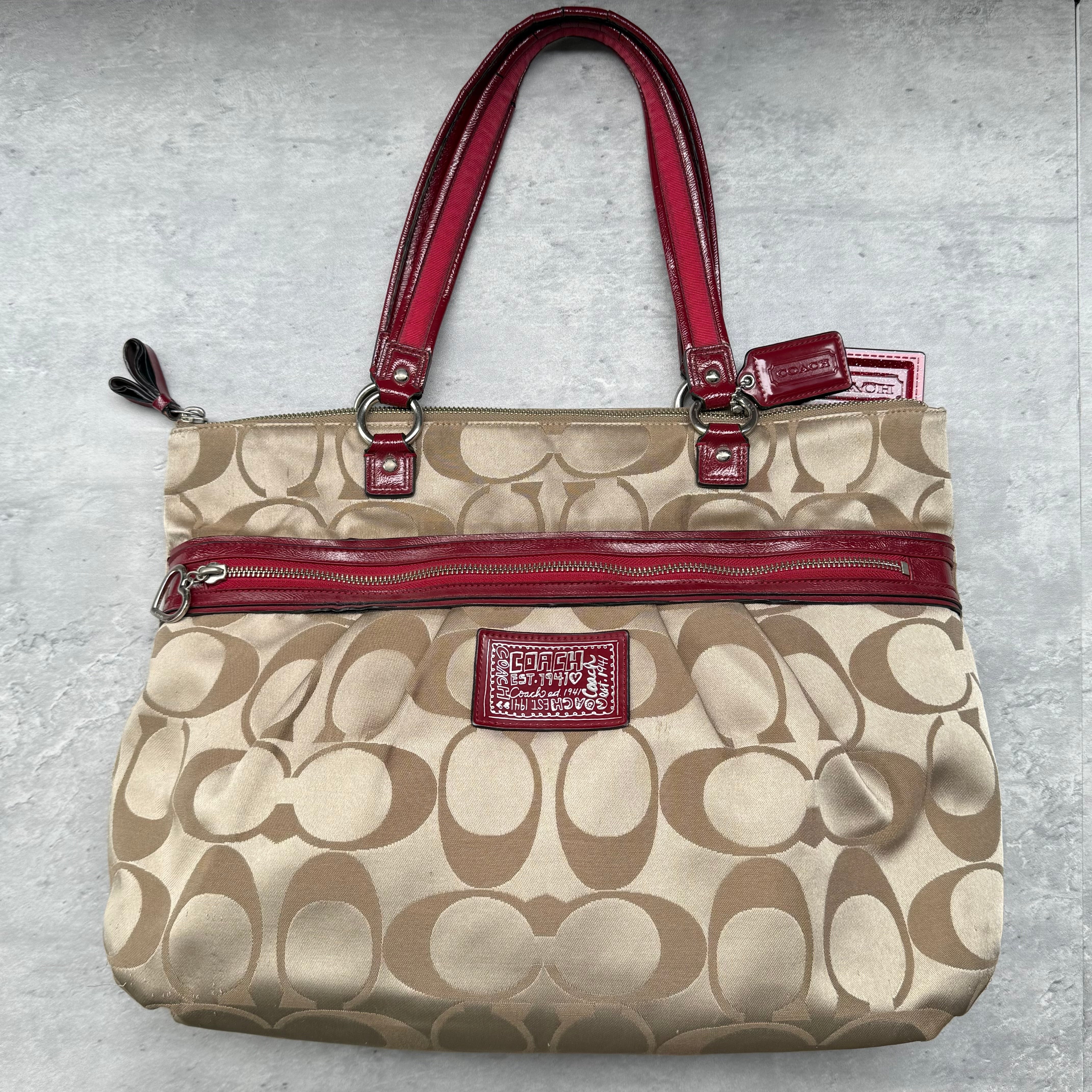 Coach Signature Stripe Gallery Tote in beige jacquard canvas with red leather trim and dual shoulder straps, featuring spacious interior with zip and slip pockets.
