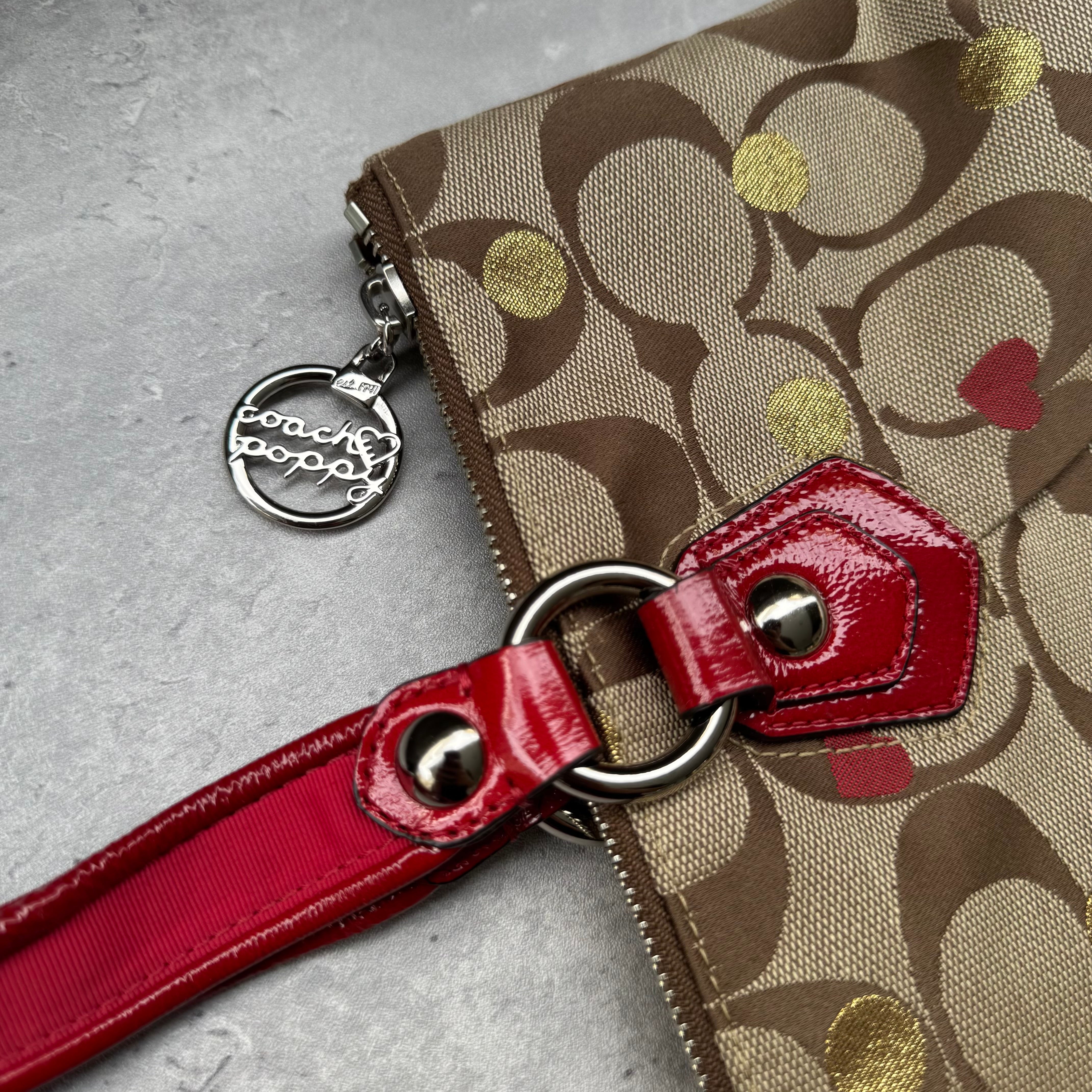 Coach Signature Poppy Laura Secret Admirer Tote Bag in brown monogram canvas with red and gold heart dot accents and red patent leather trim.