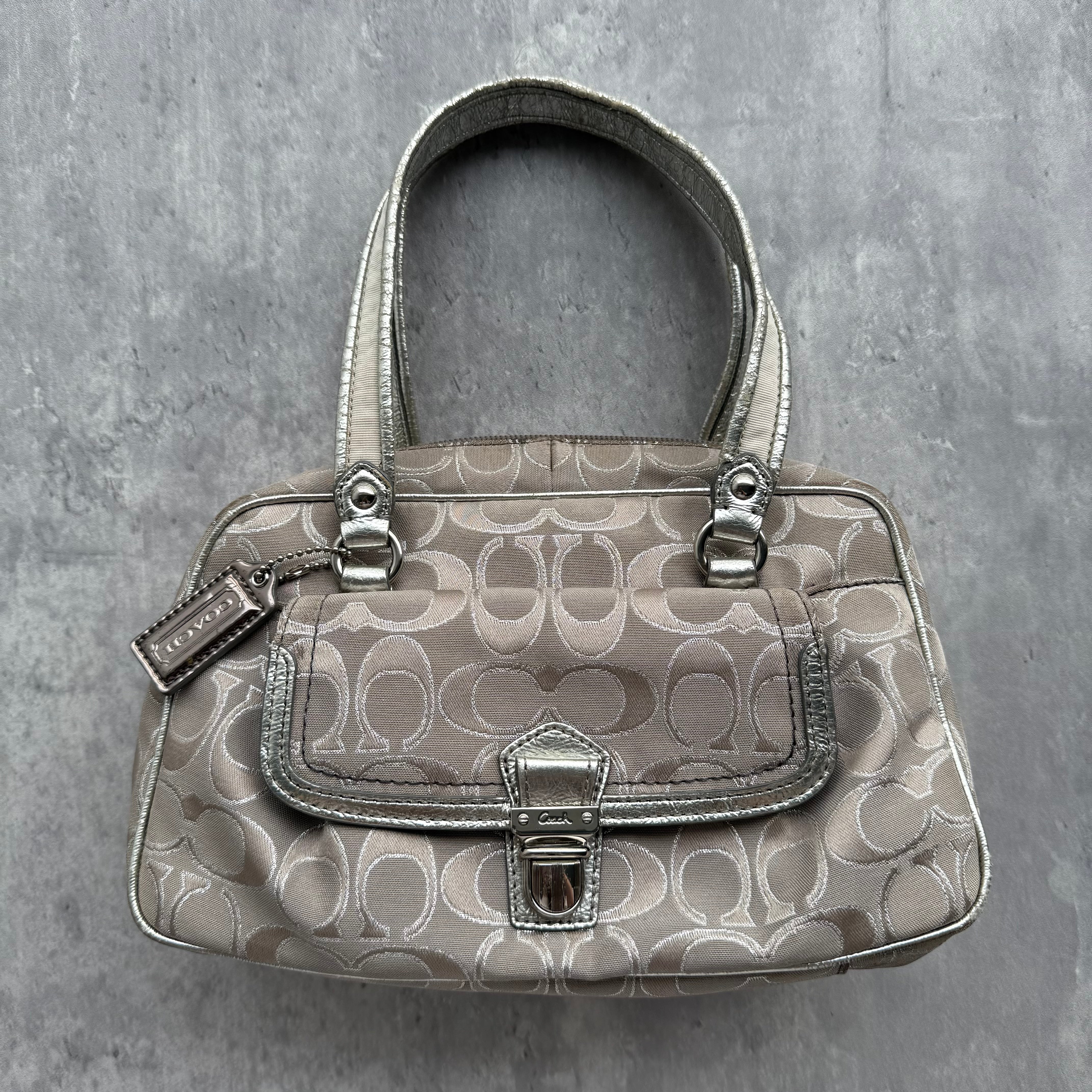 Coach Signature Poppy Metallic Shoulder Bag Silver/Grey in jacquard canvas with metallic leather trim, featuring front flap pocket, purple lining, and dual shoulder straps.
