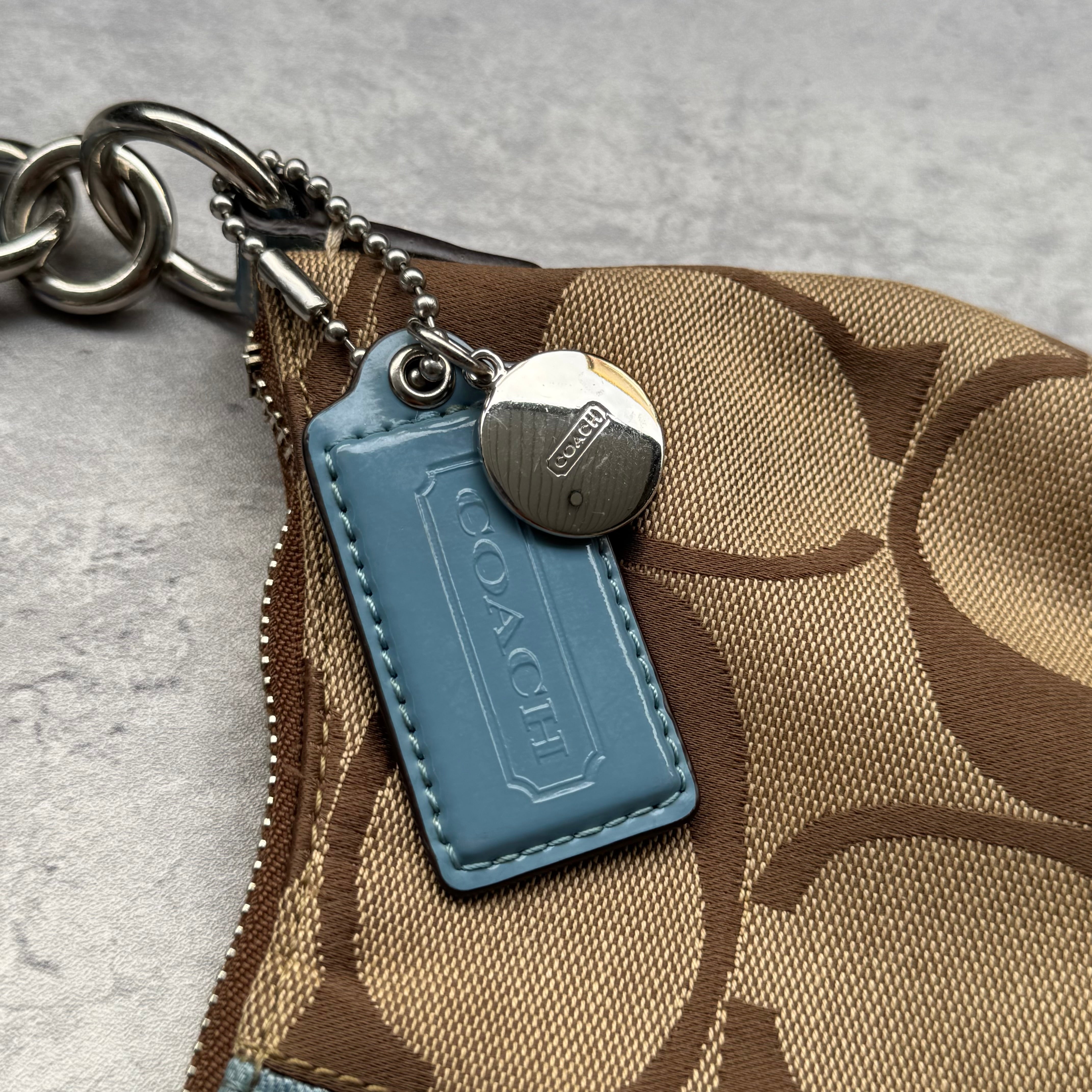 Coach Signature Stripe Shoulder Bag in brown canvas with blue leather trim and vertical logo stripe.