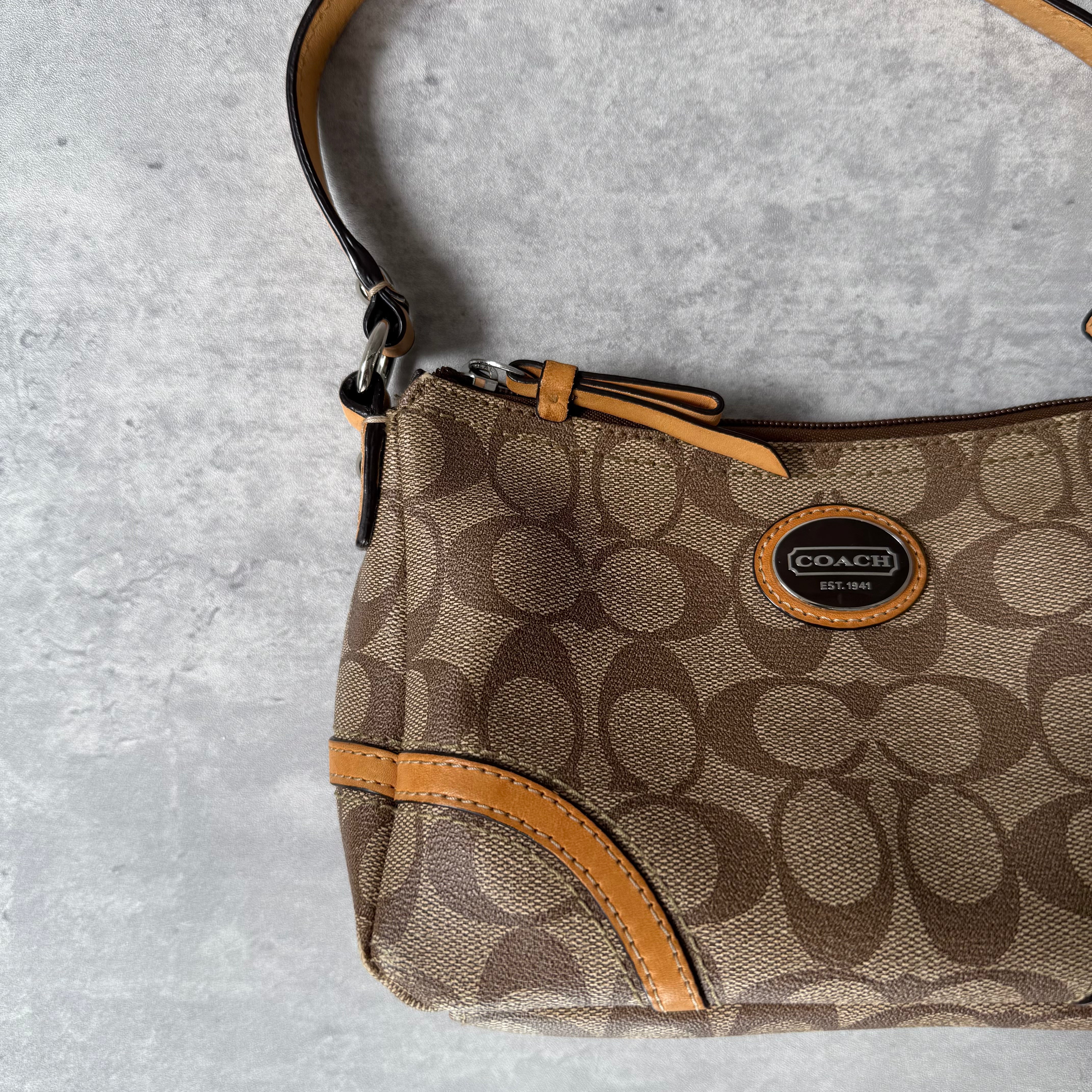 Coach Signature Sufflette Leather Shoulder Bag in beige with monogram canvas, tan leather trim, zip-top closure, and interior slip pocket