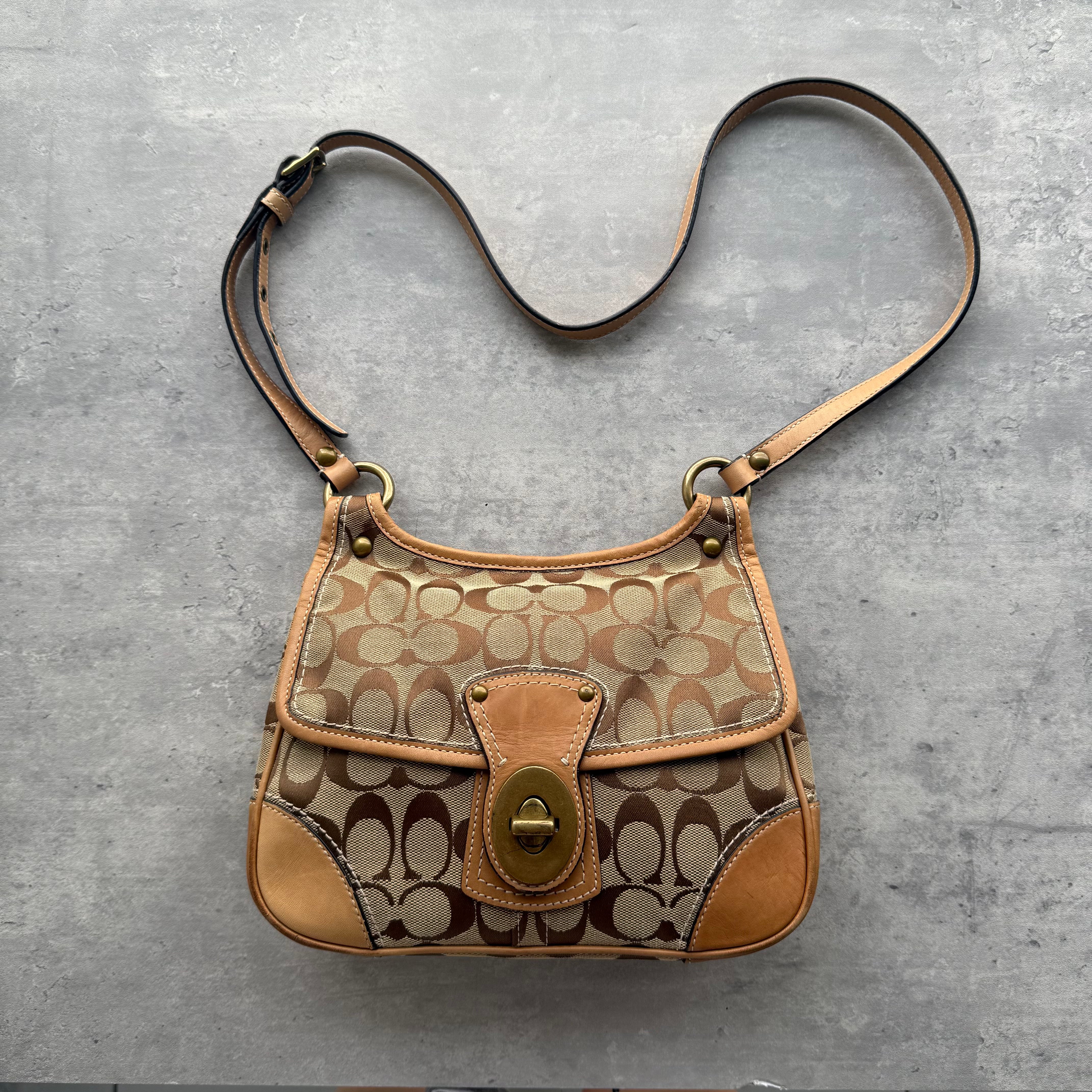 Coach Signature Turnlock Crossbody Bag in tan and beige jacquard with leather trim and gold-tone hardware.