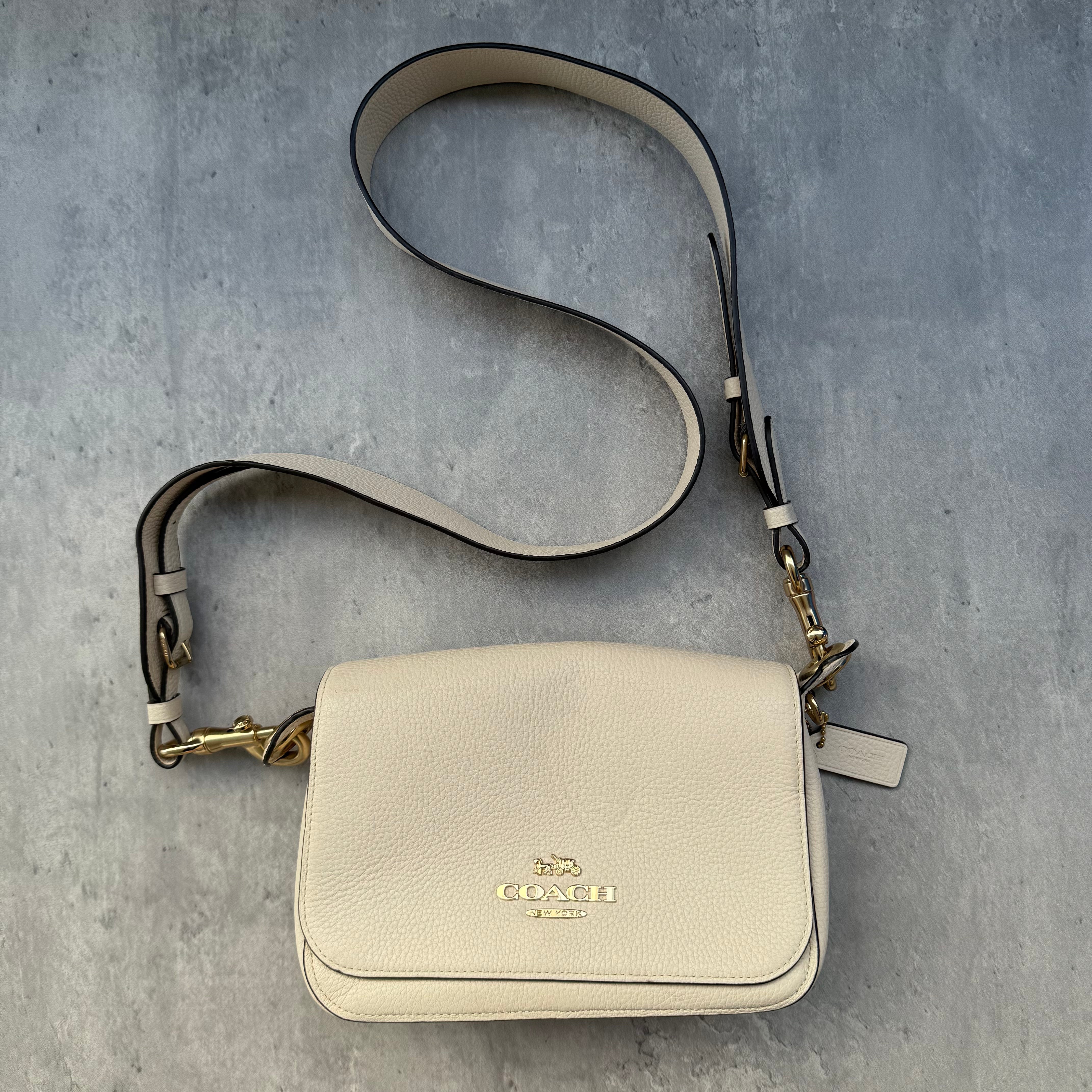 Coach Small Jes Messenger Crossbody Bag in white pebbled leather with gold-tone hardware, tan interior lining, and adjustable strap.