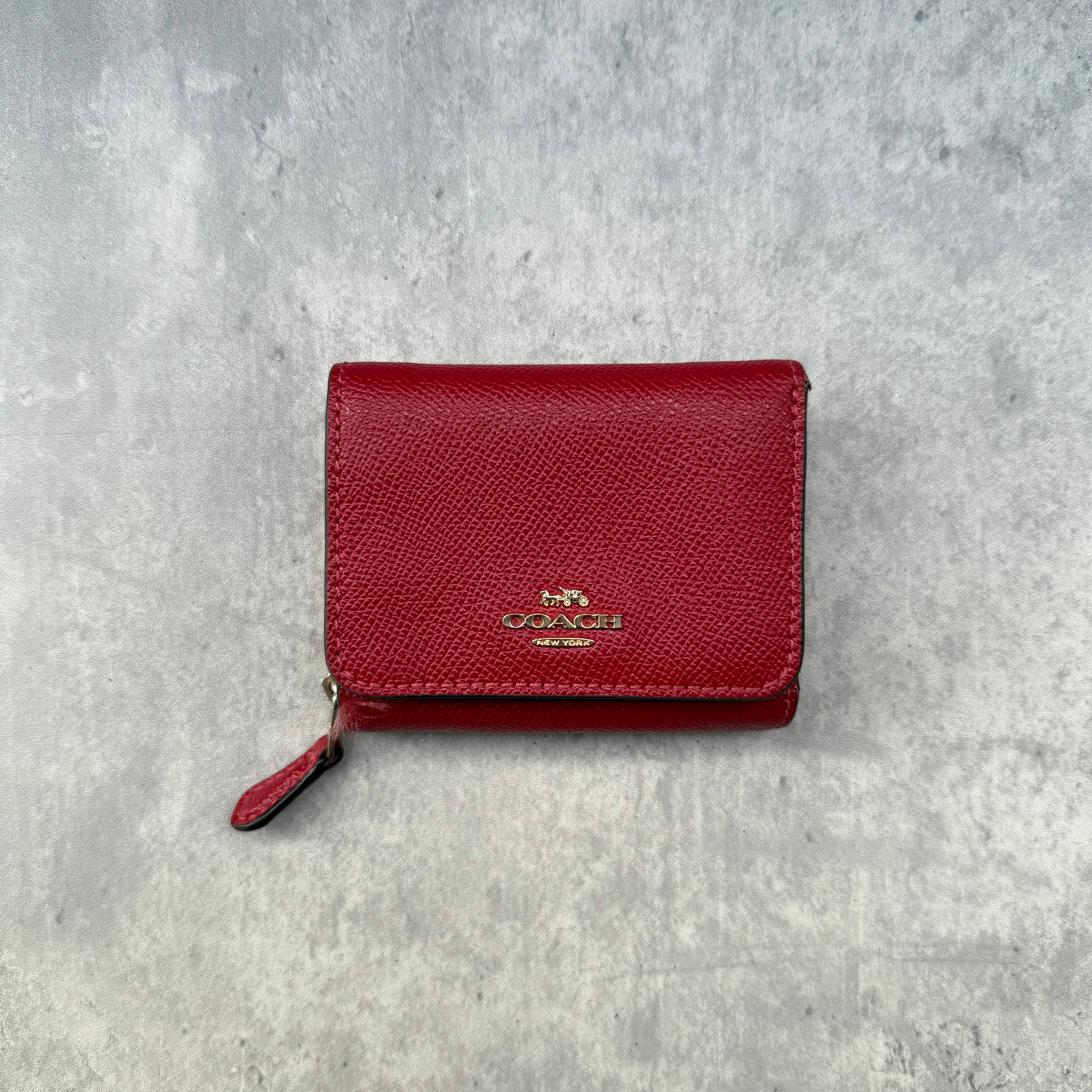 Coach Small Trifold Wallet in Red Pebbled Leather with gold-tone logo and zip coin pocket.