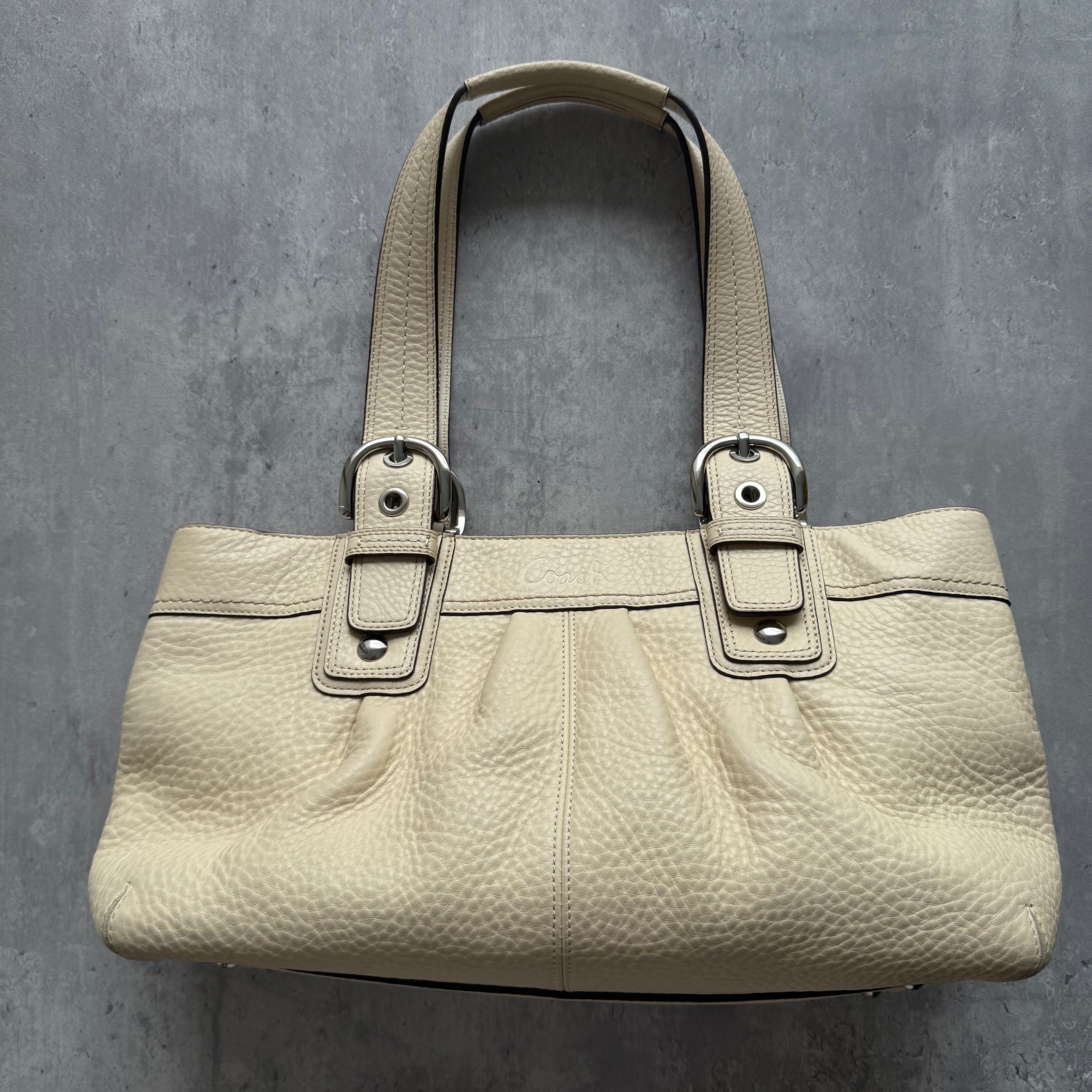 Coach Soho Pleated Leather Satchel Bag in cream pebble leather with silver-tone hardware and pink interior lining.