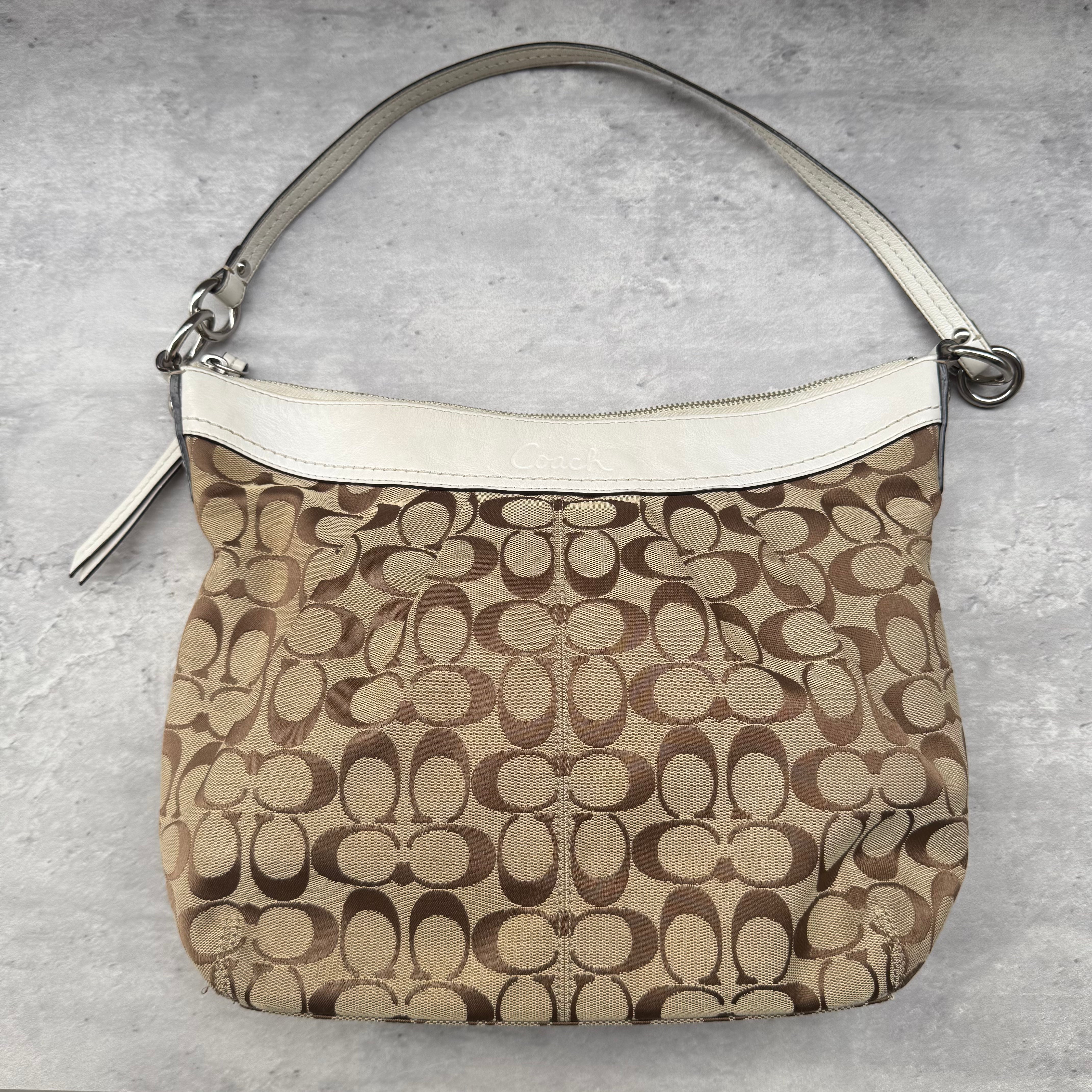 Coach Y2K Signature Canvas Hobo Shoulder Bag in white and beige, crafted from jacquard canvas with leather trim and silver-tone hardware.