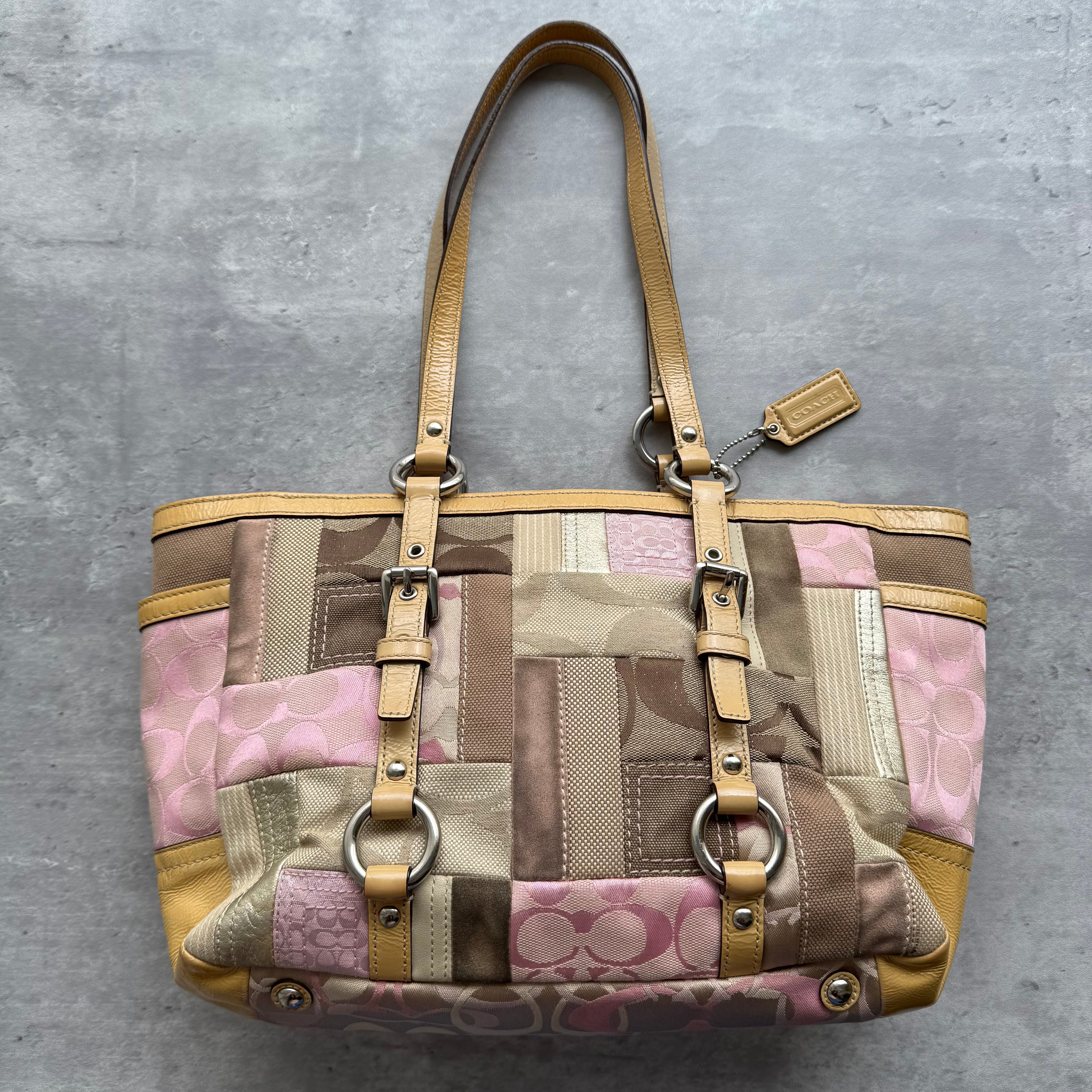 Coach Signature Patchwork Gallery Tote Bag in beige, brown, and pink with mixed fabric panels, leather trim, and dual shoulder straps with ring and buckle details.