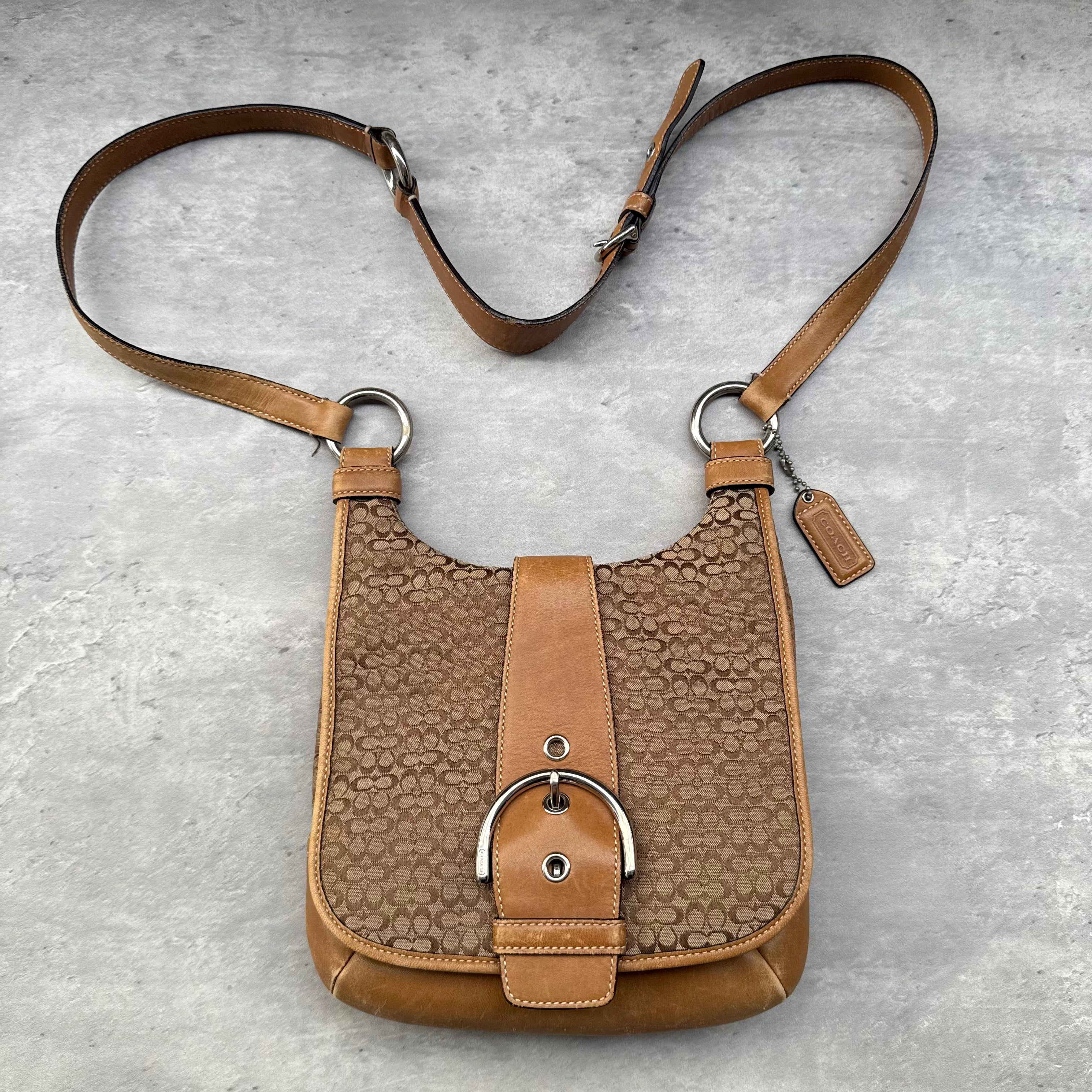 Coach Y2K Signature Soho Crossbody Bag in beige and tan with front buckle detail and adjustable leather strap.