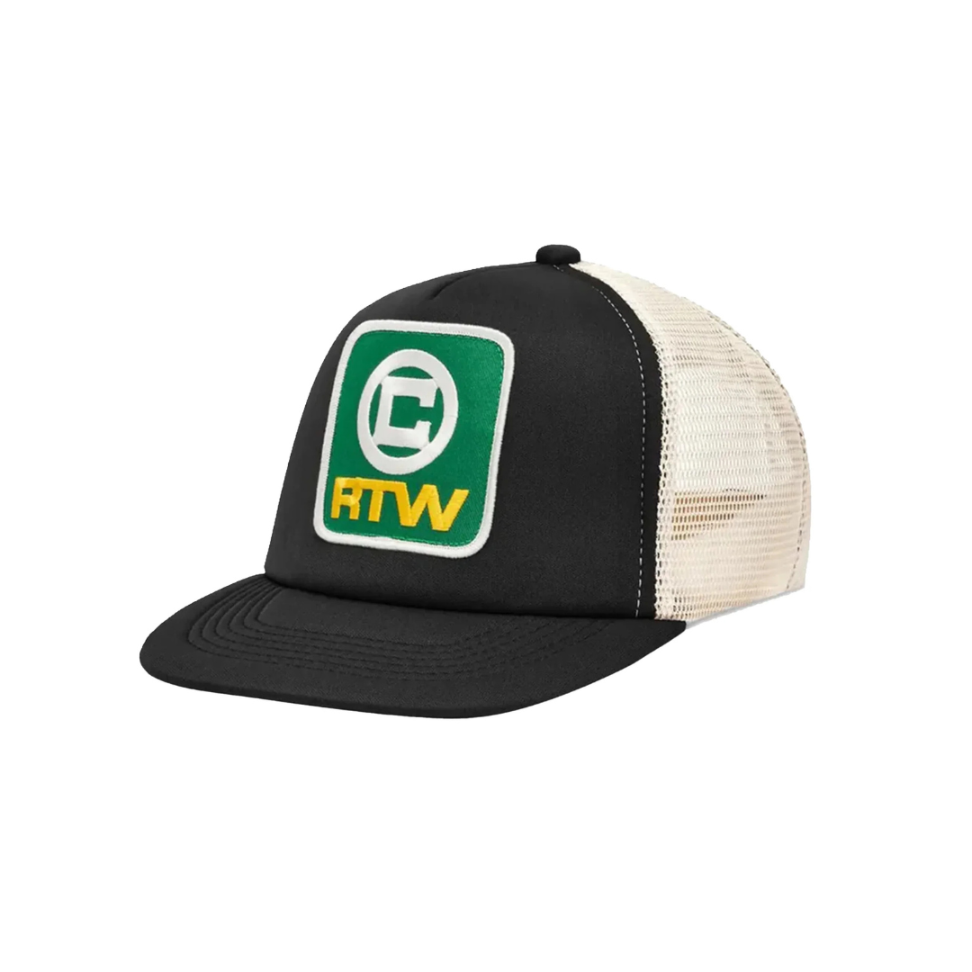 Corteiz RTW Box Black Trucker Hat with green and yellow embroidered patch, black front panel, and beige mesh back.