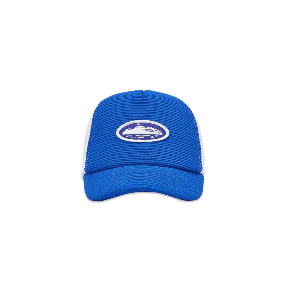Corteiz Short Peak Trucker Hat in royal blue, featuring ribbed front panel and embroidered yacht logo with white mesh back