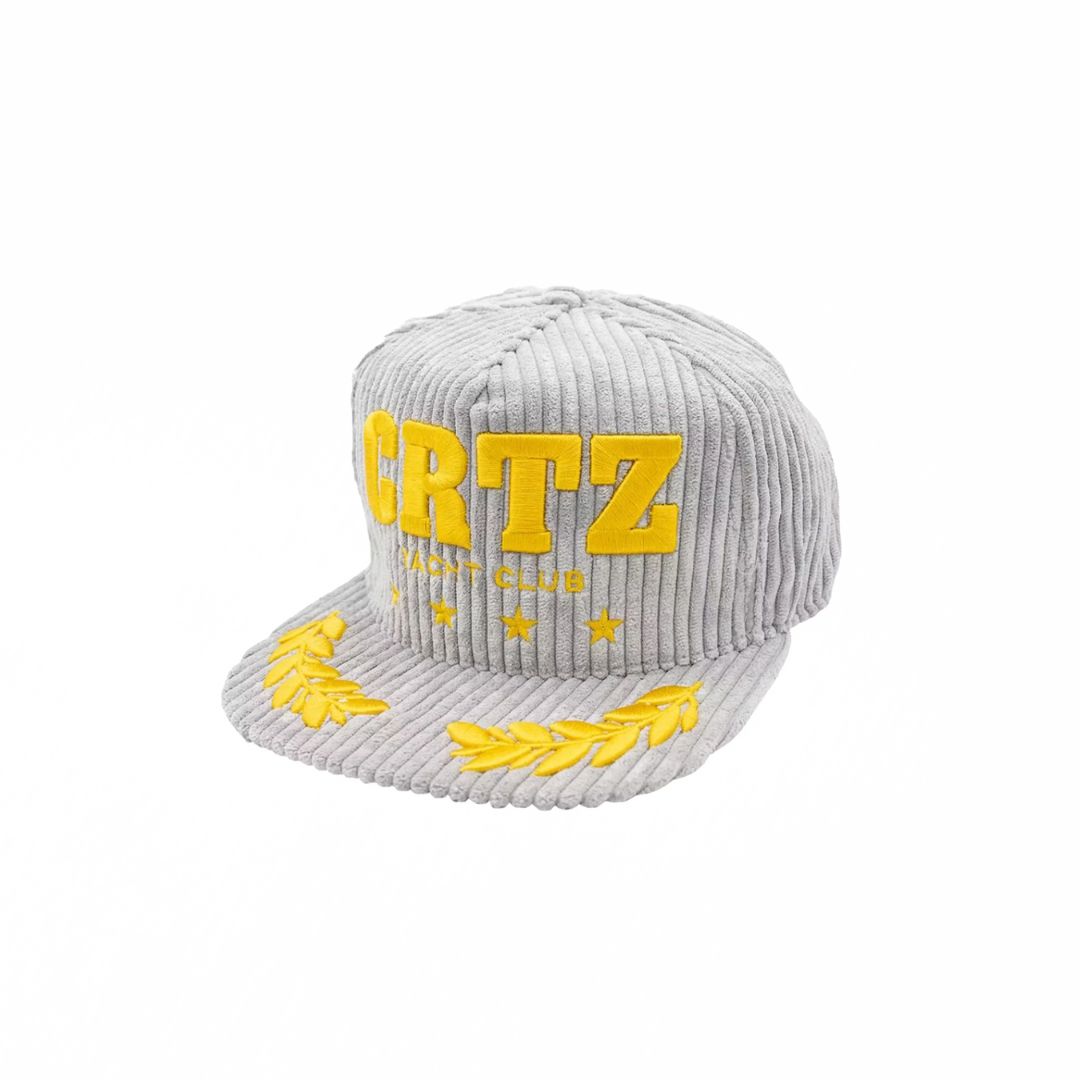 Corteiz Soho Yacht Club Cap in grey ribbed corduroy with bold yellow CRTZ embroidery and laurel details