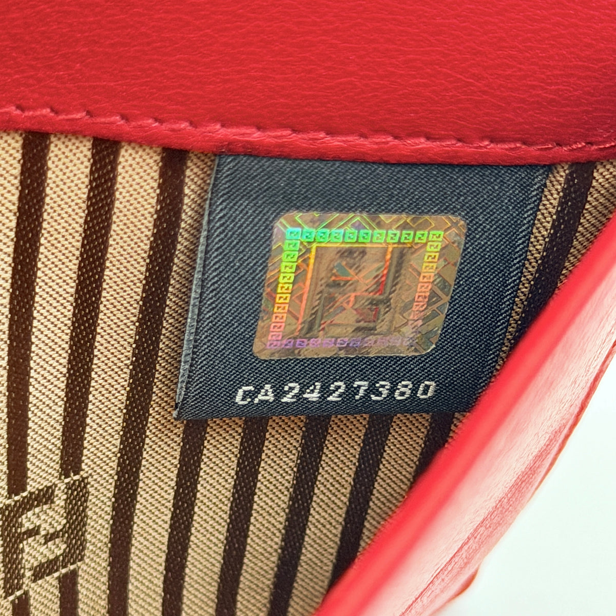 Fendi FF Logo Buckle Flap Continental Wallet in red leather with gold hardware, displayed closed on a white background.