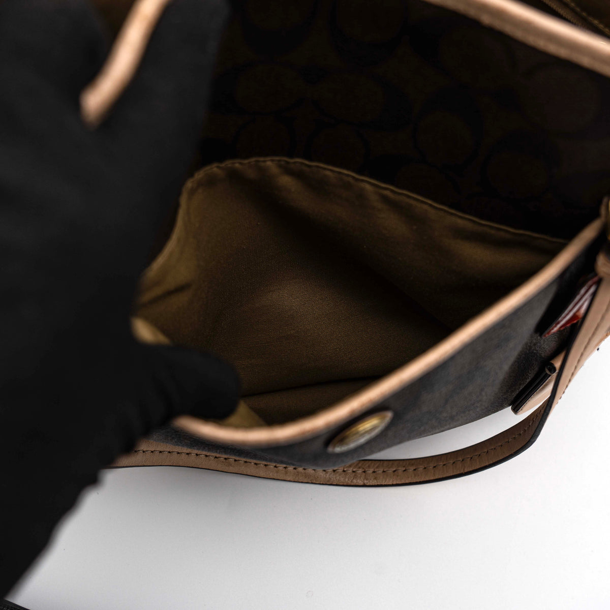 Coach Signature Peyton Pocket tote bag in brown canvas with tan leather trim, shown with both handles and detachable strap.