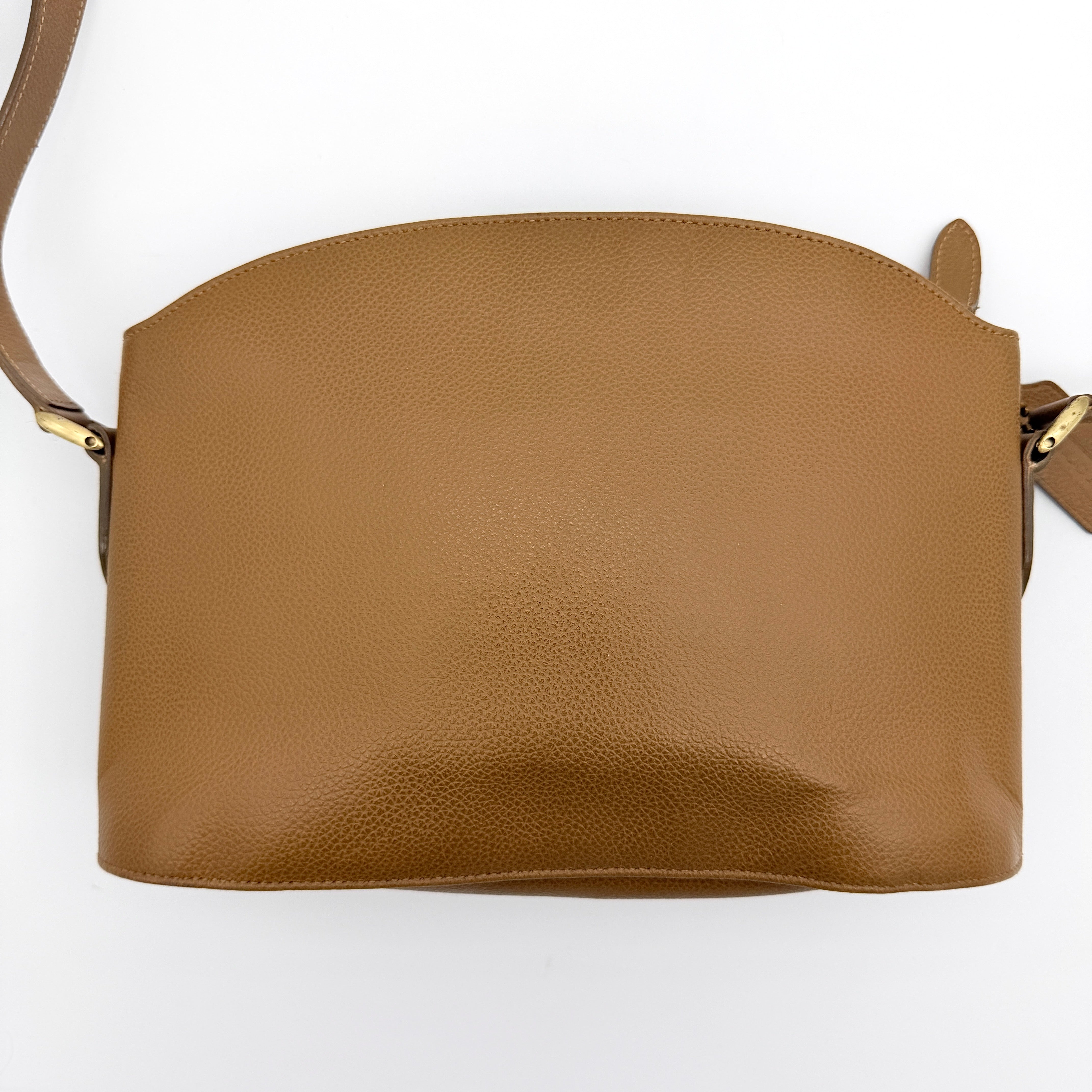 Coach tan leather crossbody bag with gold-tone hardware and adjustable strap, photographed on a white background.