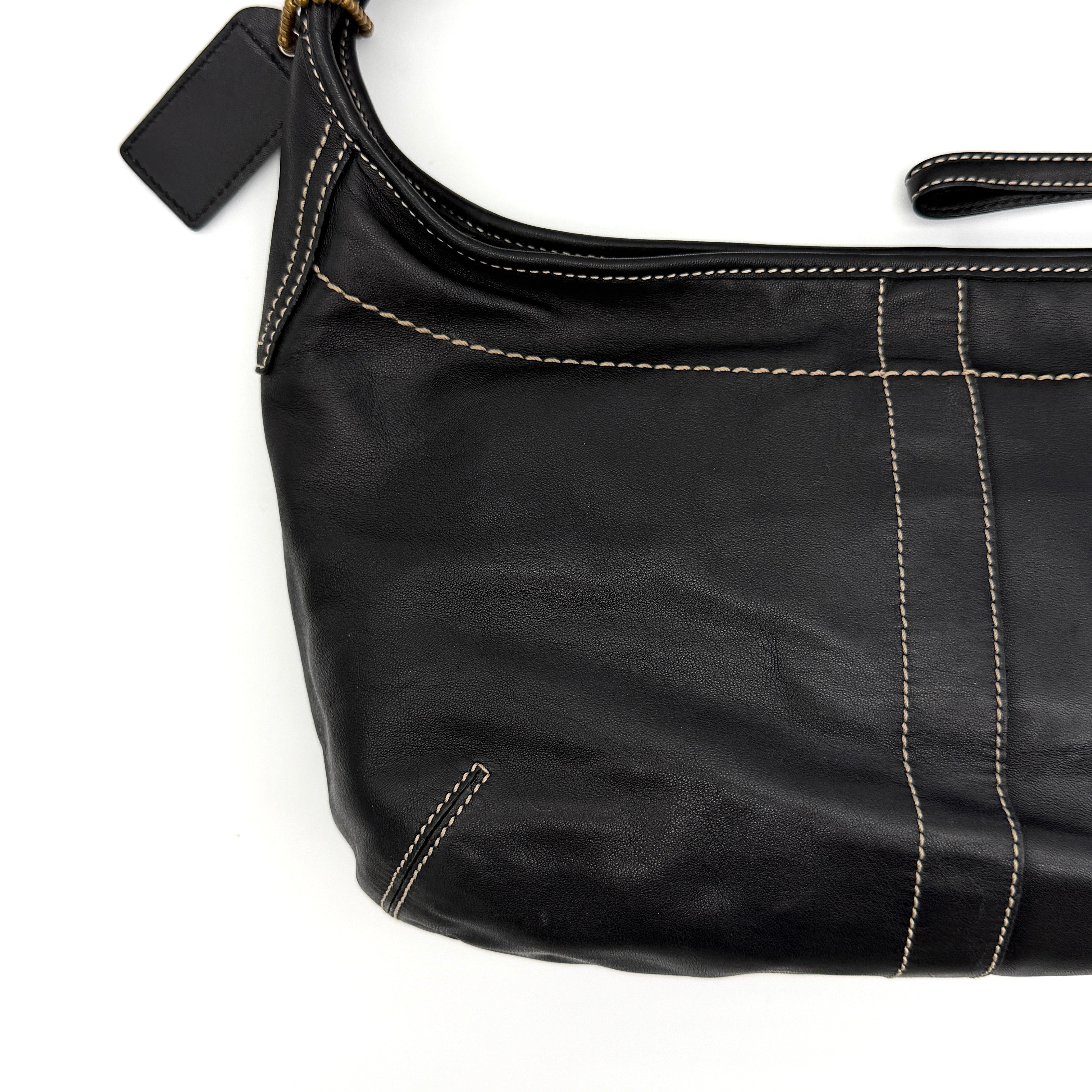 Coach Signature Ergo Hobo Shoulder Bag in black leather with contrast stitching and brass hardware, displayed against a white background.