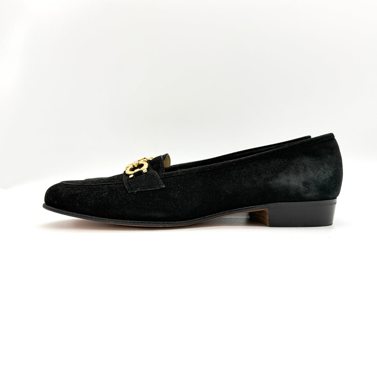 Salvatore Ferragamo black suede loafers with gold Gancini horsebit detail, displayed side by side on a white background.