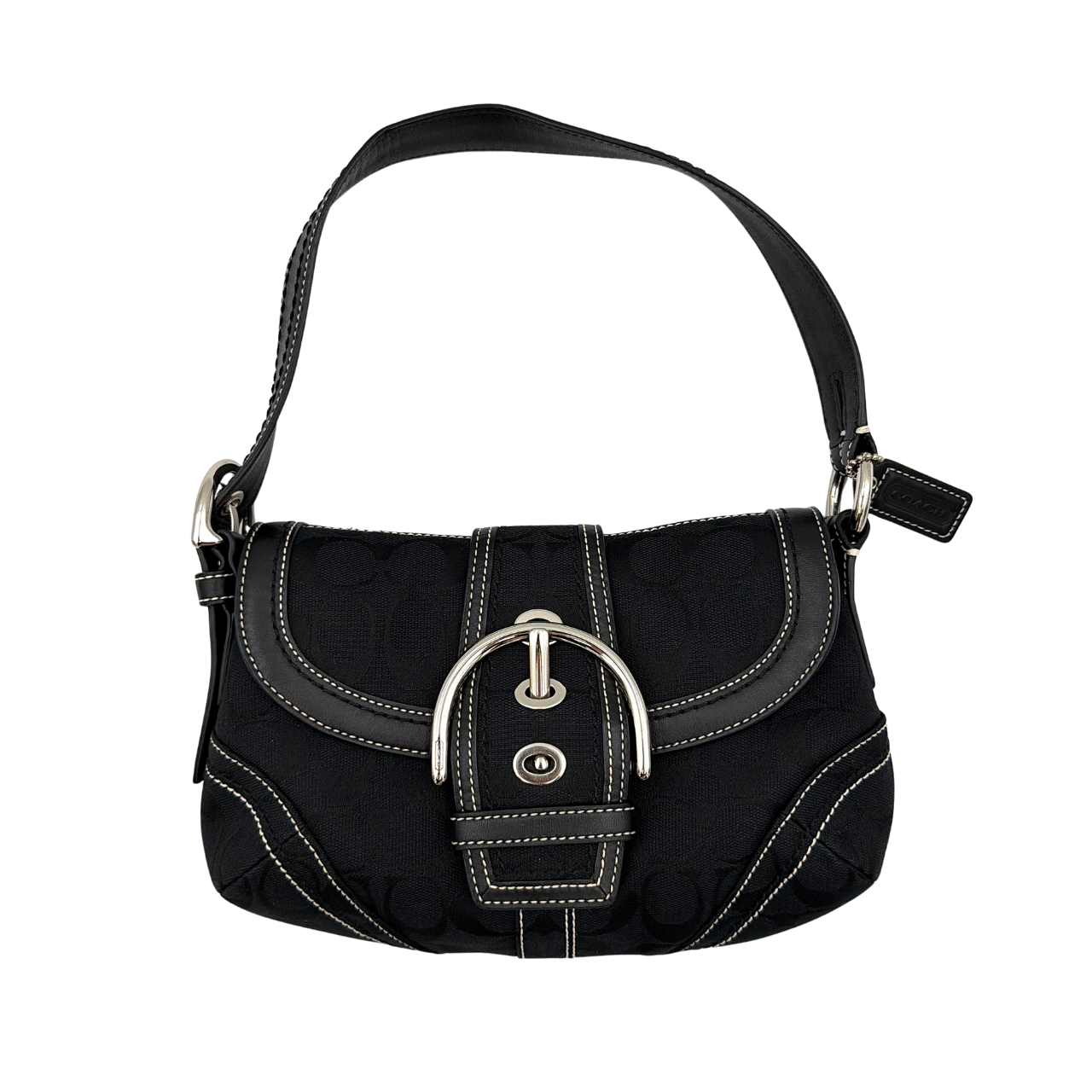 Coach black Signature Soho shoulder bag with oversized silver buckle, cream contrast stitching, and monogram jacquard canvas backdrop.