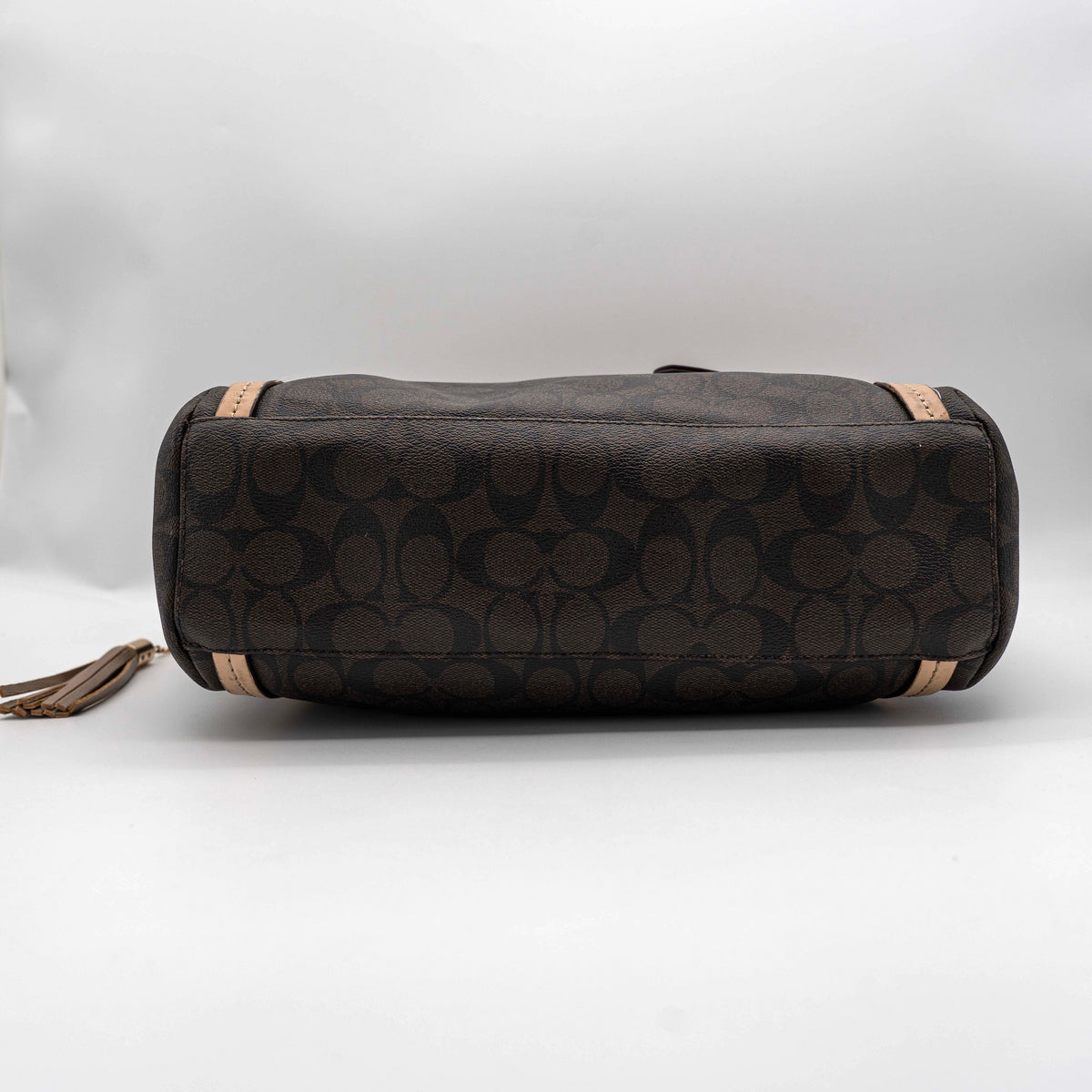 Coach Signature Peyton Pocket tote bag in brown canvas with tan leather trim, shown with both handles and detachable strap.