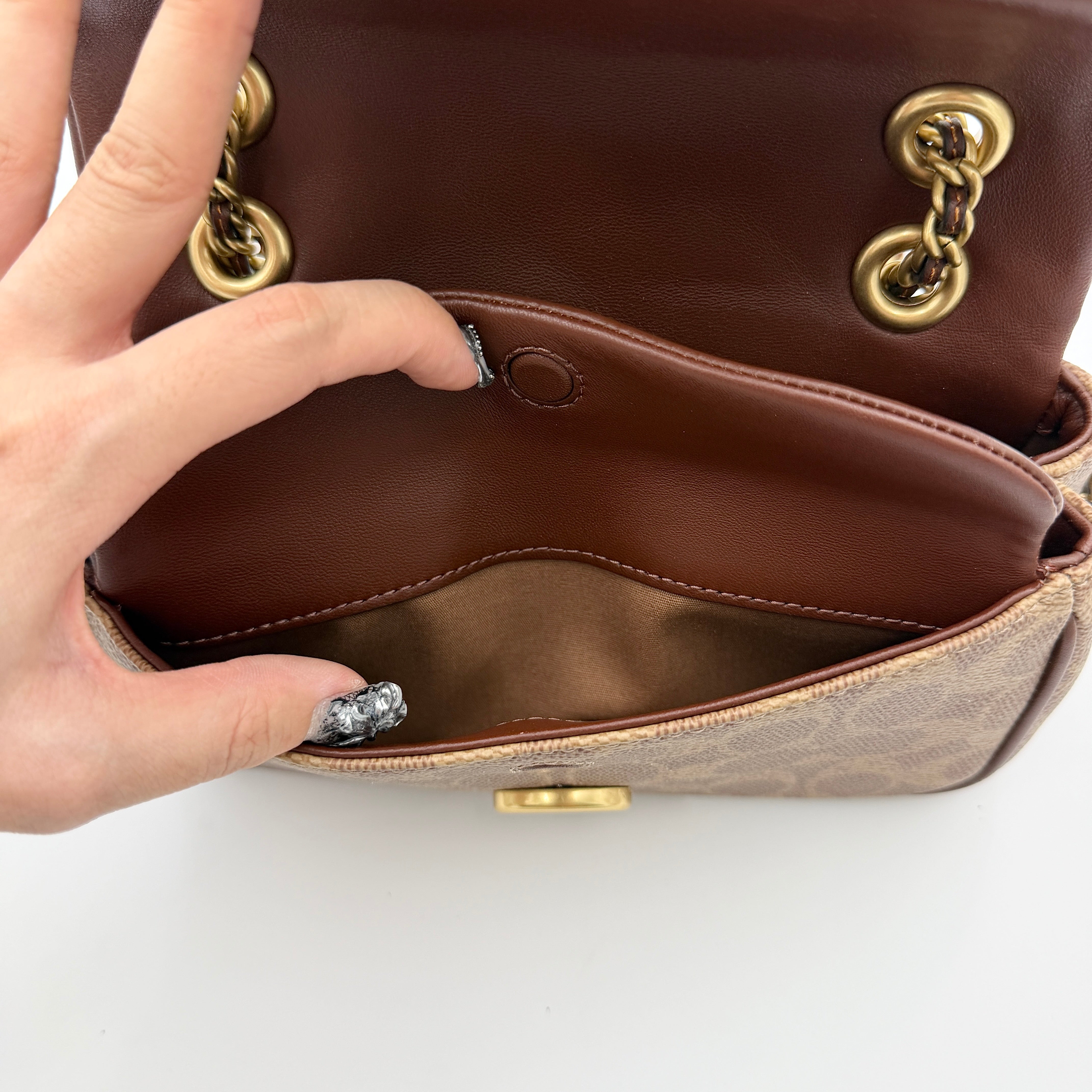 Coach Signature Quilted Tabby Shoulder Bag in brown monogram canvas with gold chain strap and oversized C clasp.