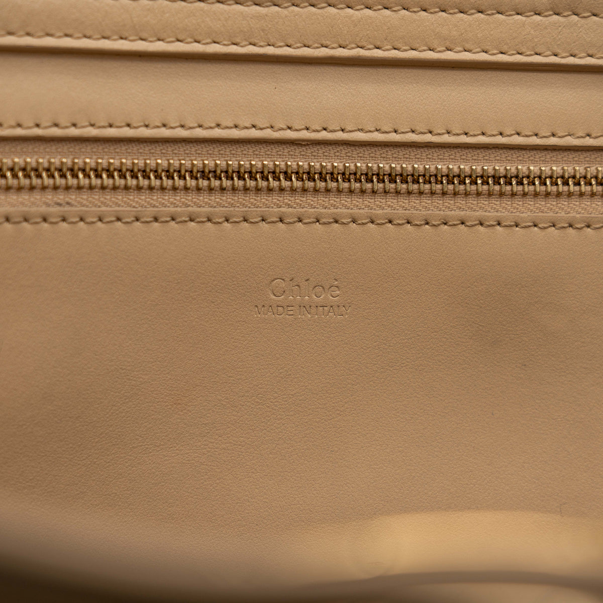 Chloé C Zipped Tote Bag in beige leather with gold hardware, shown with structured dual straps and front logo detail.