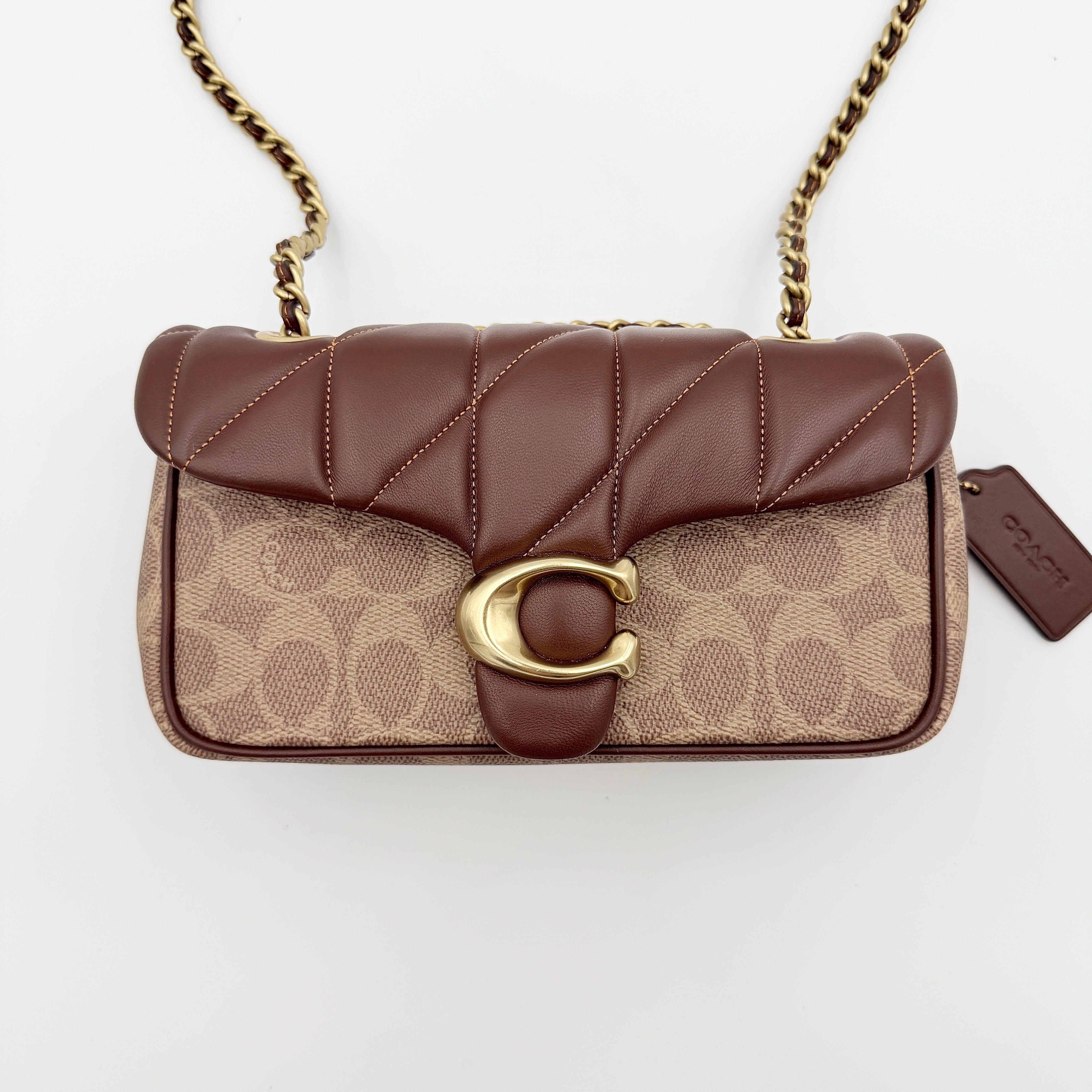 Coach Signature Quilted Tabby Shoulder Bag in brown monogram canvas with gold chain strap and oversized C clasp.