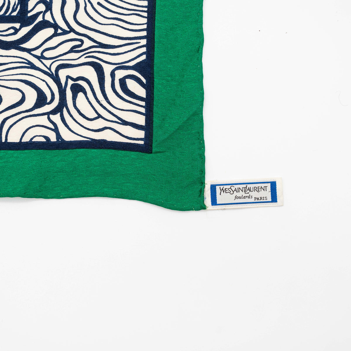 Yves Saint Laurent geometric silk scarf in green and black with abstract and square patterns, featuring a corner YSL label.