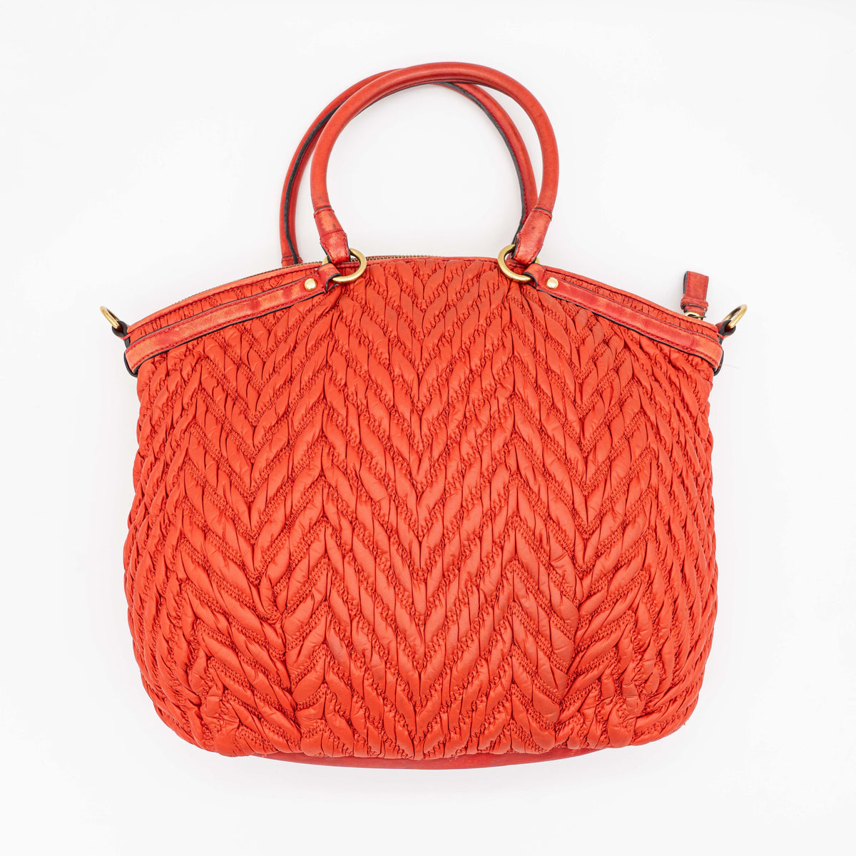 Coach Madison 2Way shoulder bag in rich red quilted texture with gold hardware, top handles, and detachable strap, displayed on a white background.