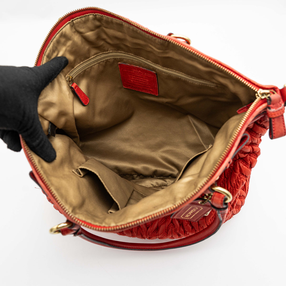 Coach Madison 2Way shoulder bag in rich red quilted texture with gold hardware, top handles, and detachable strap, displayed on a white background.