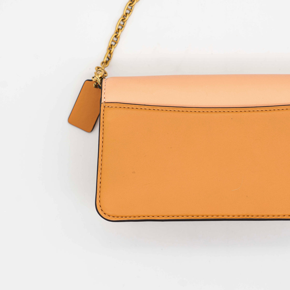 Coach Beat Crossbody Clutch 2Way in blush, tan, and red leather with brass hardware and detachable strap, displayed with chain handle.