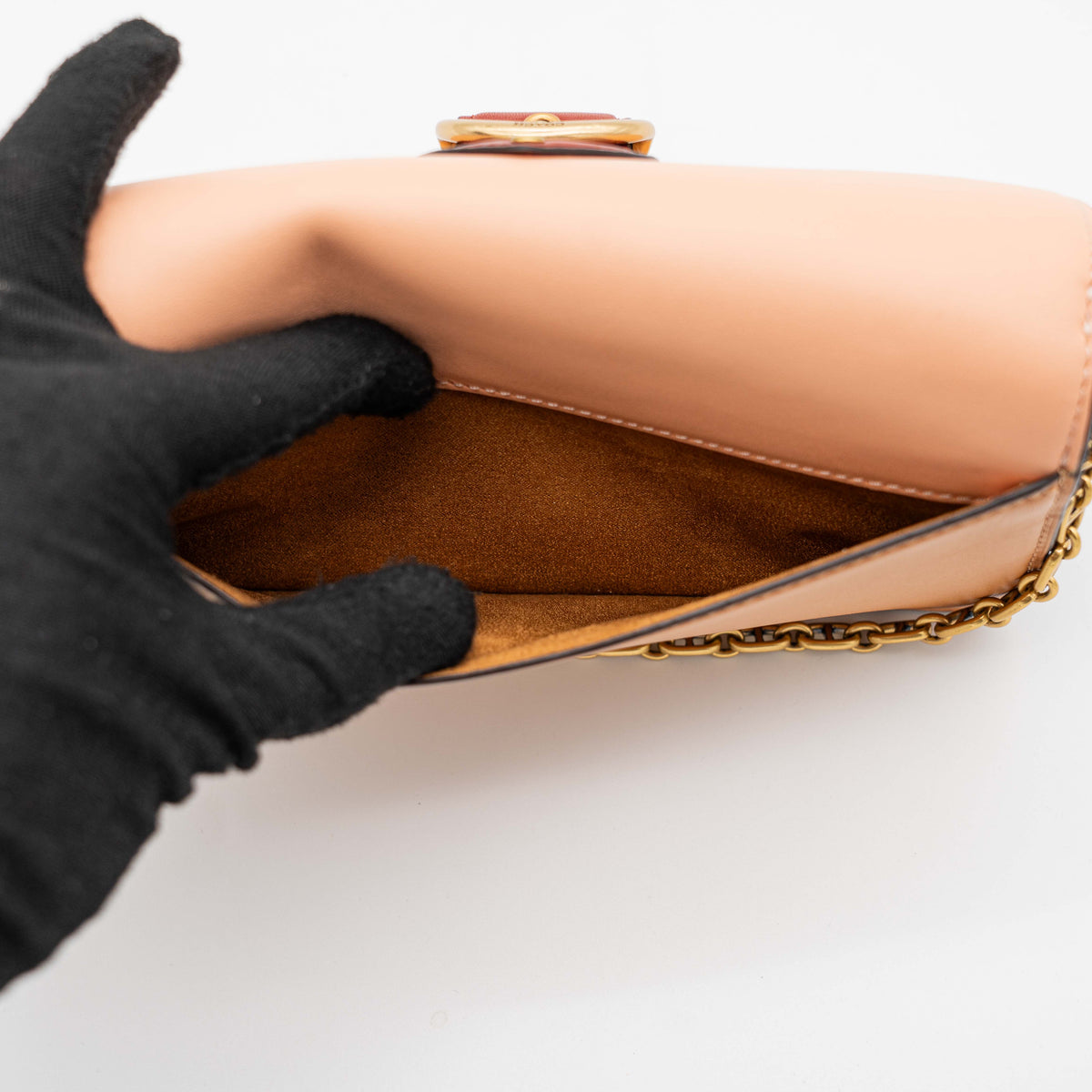 Coach Beat Crossbody Clutch 2Way in blush, tan, and red leather with brass hardware and detachable strap, displayed with chain handle.