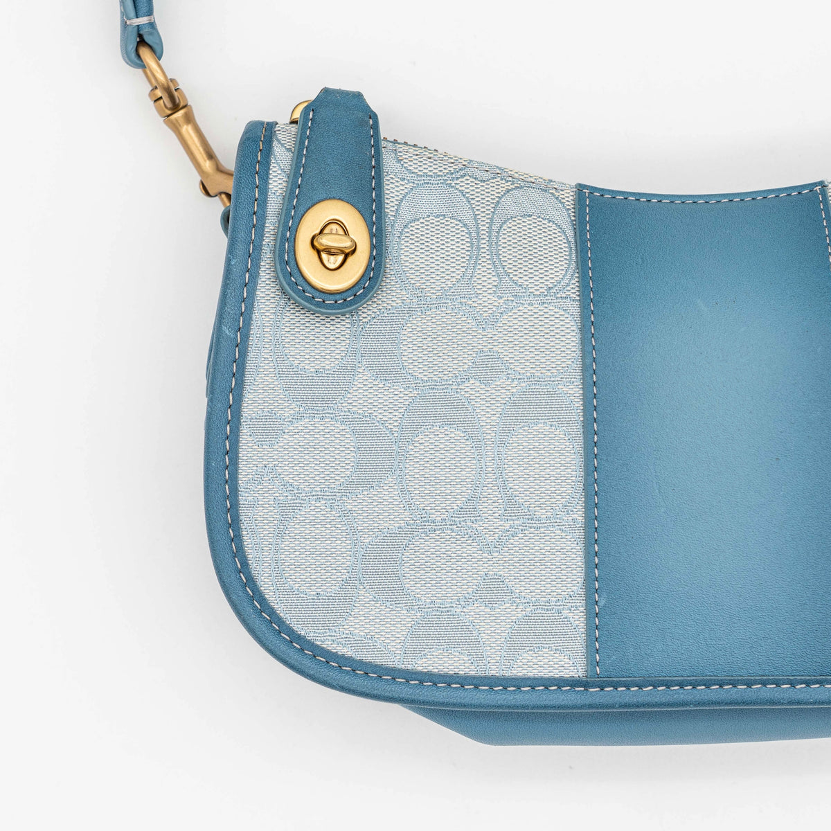Coach 2Way Signature Swinger Shoulder Bag in light blue monogram canvas and leather with dinosaur and rainbow patches, shown with detachable strap.