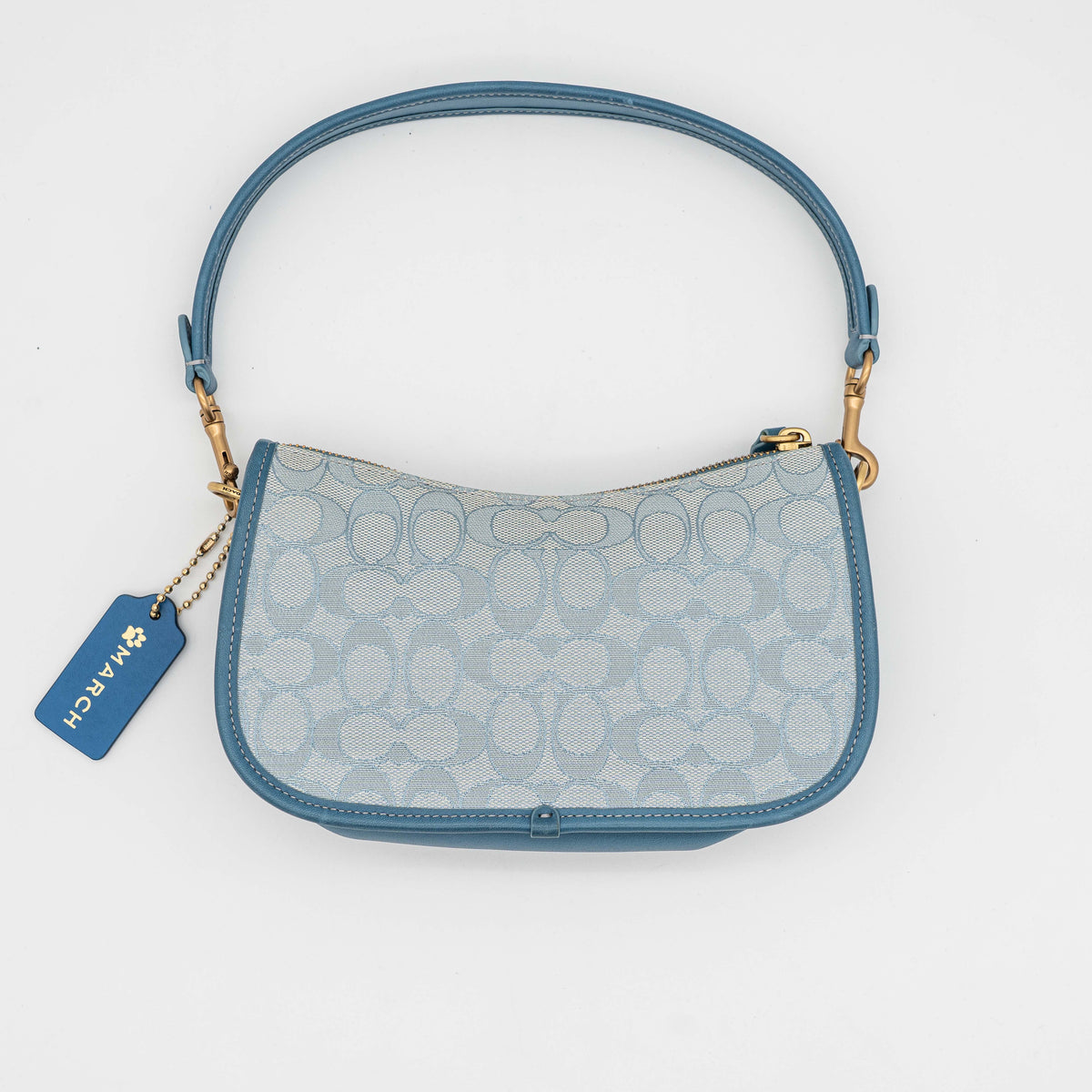 Coach 2Way Signature Swinger Shoulder Bag in light blue monogram canvas and leather with dinosaur and rainbow patches, shown with detachable strap.