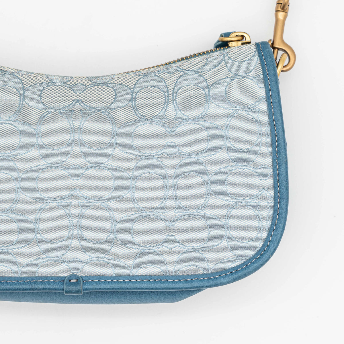 Coach 2Way Signature Swinger Shoulder Bag in light blue monogram canvas and leather with dinosaur and rainbow patches, shown with detachable strap.