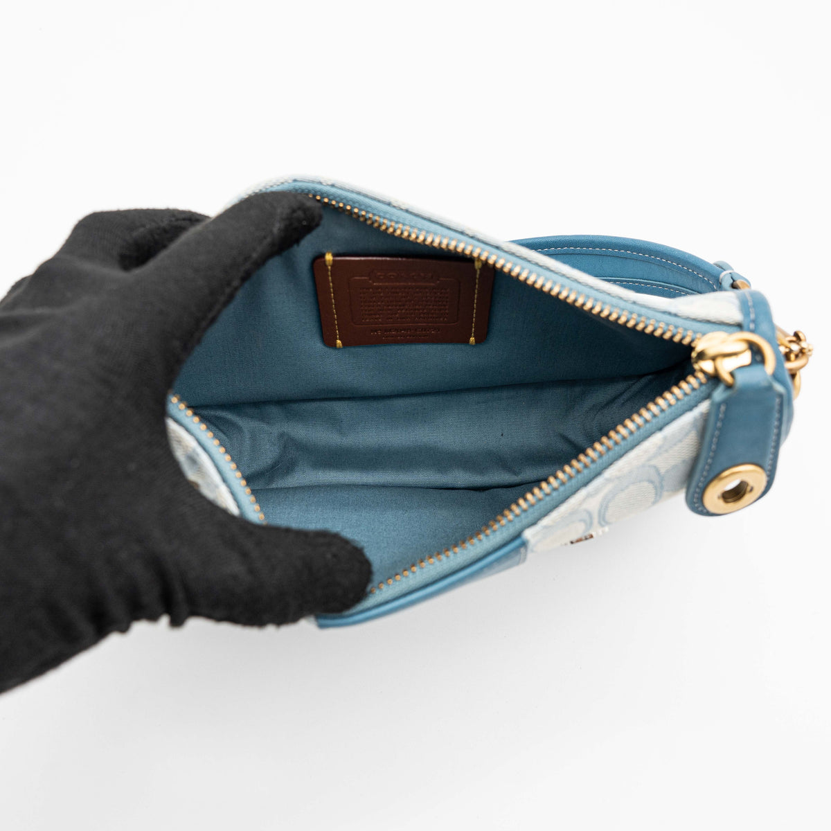 Coach 2Way Signature Swinger Shoulder Bag in light blue monogram canvas and leather with dinosaur and rainbow patches, shown with detachable strap.