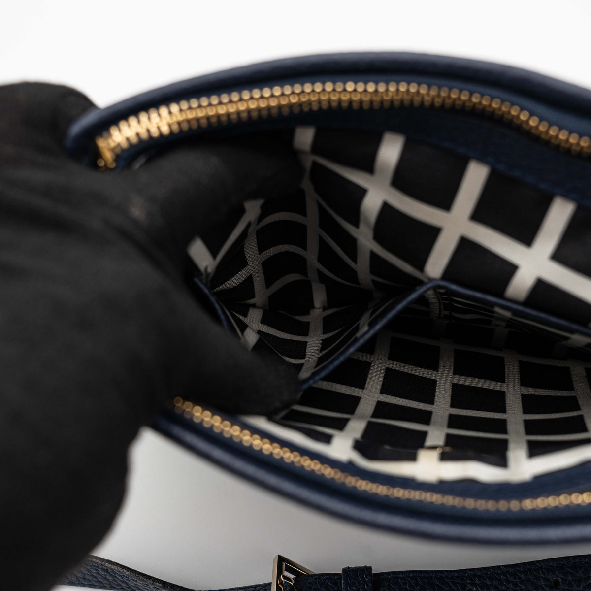 Kate Spade navy blue crossbody bag in pebbled leather, shown with adjustable strap and gold-tone accents.