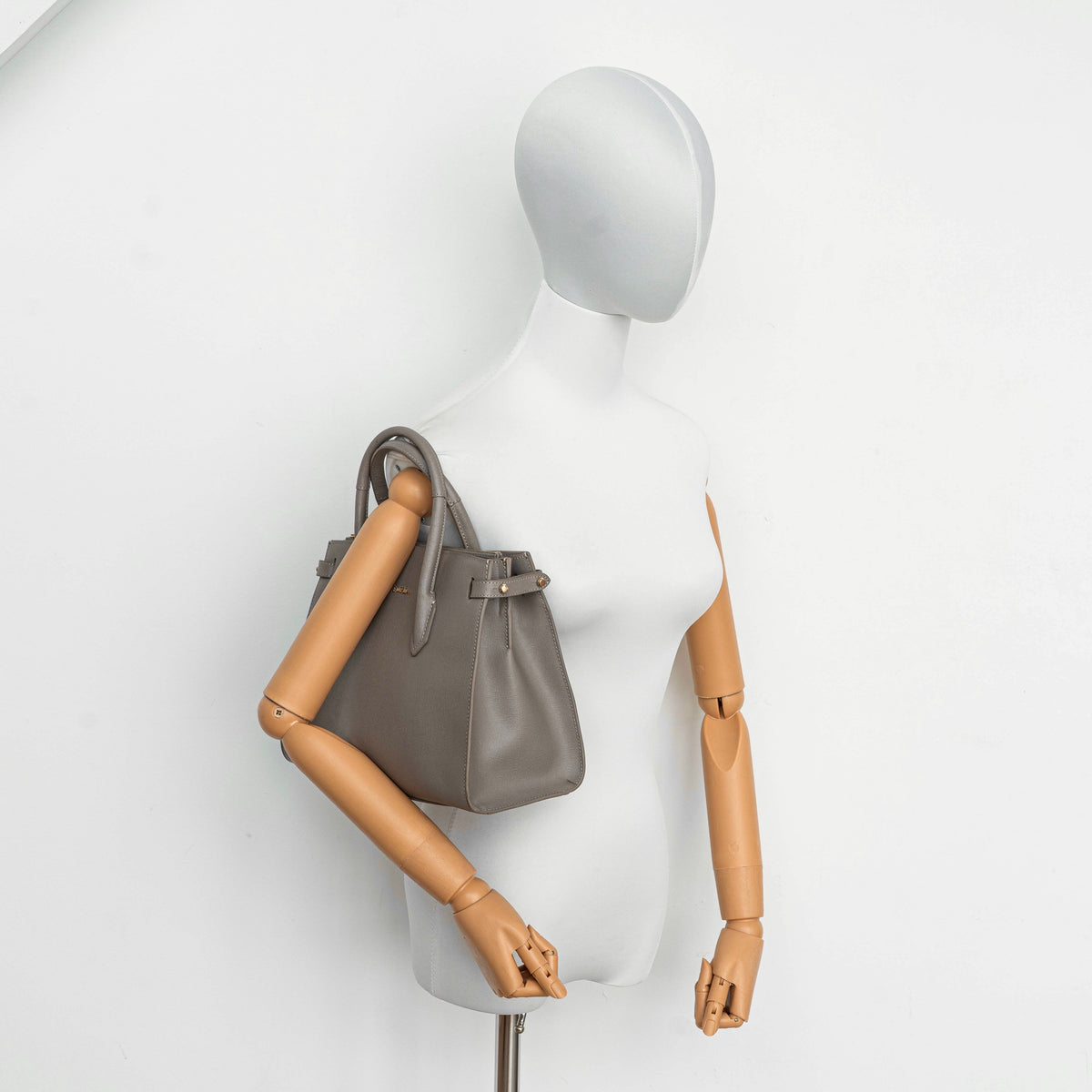 Furla grey Pin tote bag with top handles, gold hardware, and detachable strap against a white background.