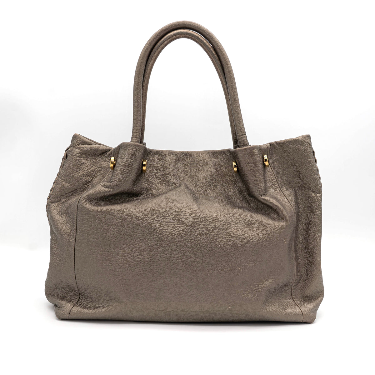 Furla taupe leather shoulder bag with gold hardware and braided detailing, photographed against a white background.